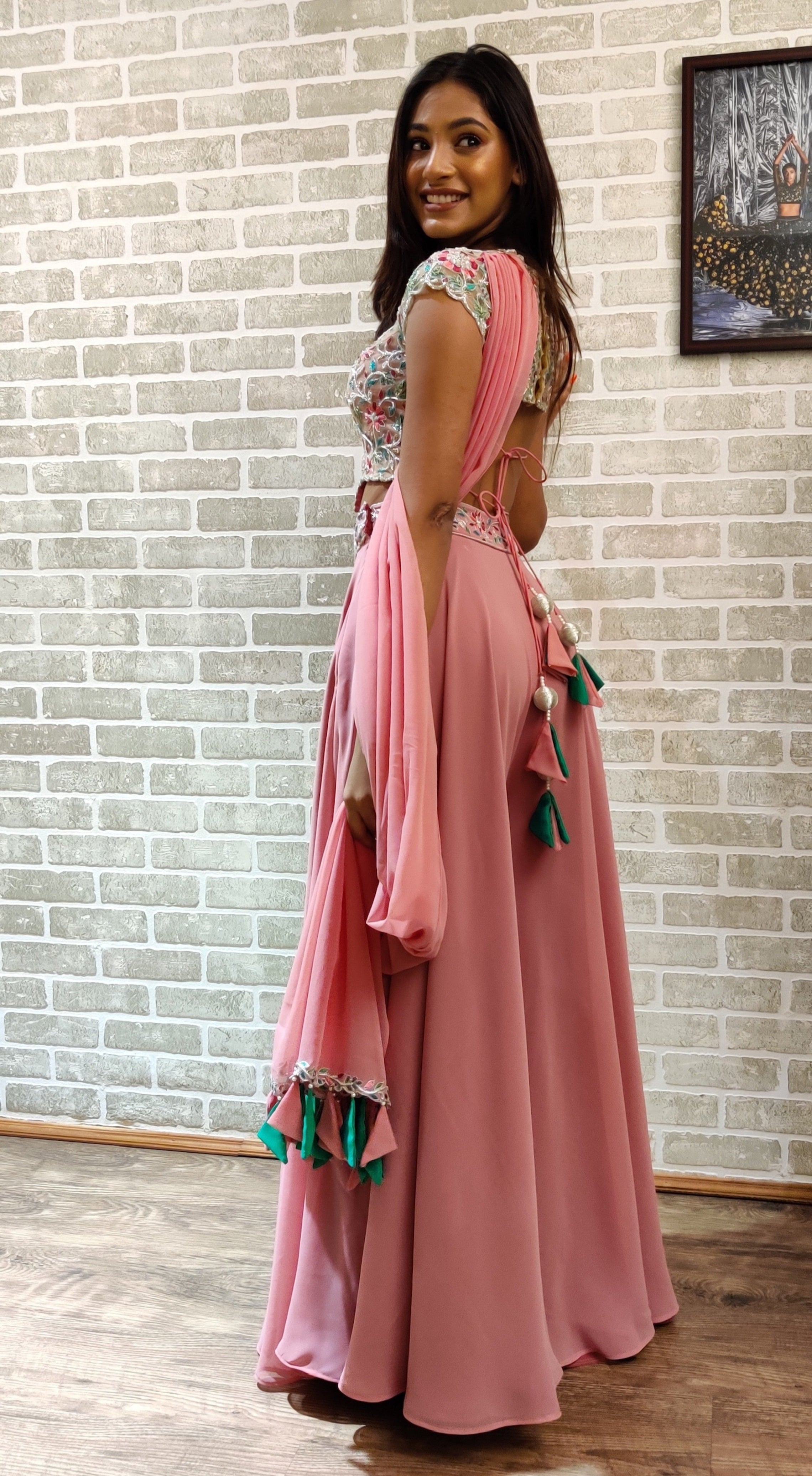 Miss India 2018 and actress Anukreethy Vas in a powder pink georgette sharara with palazzo pants. Showing blouse back design and back design of the sharara