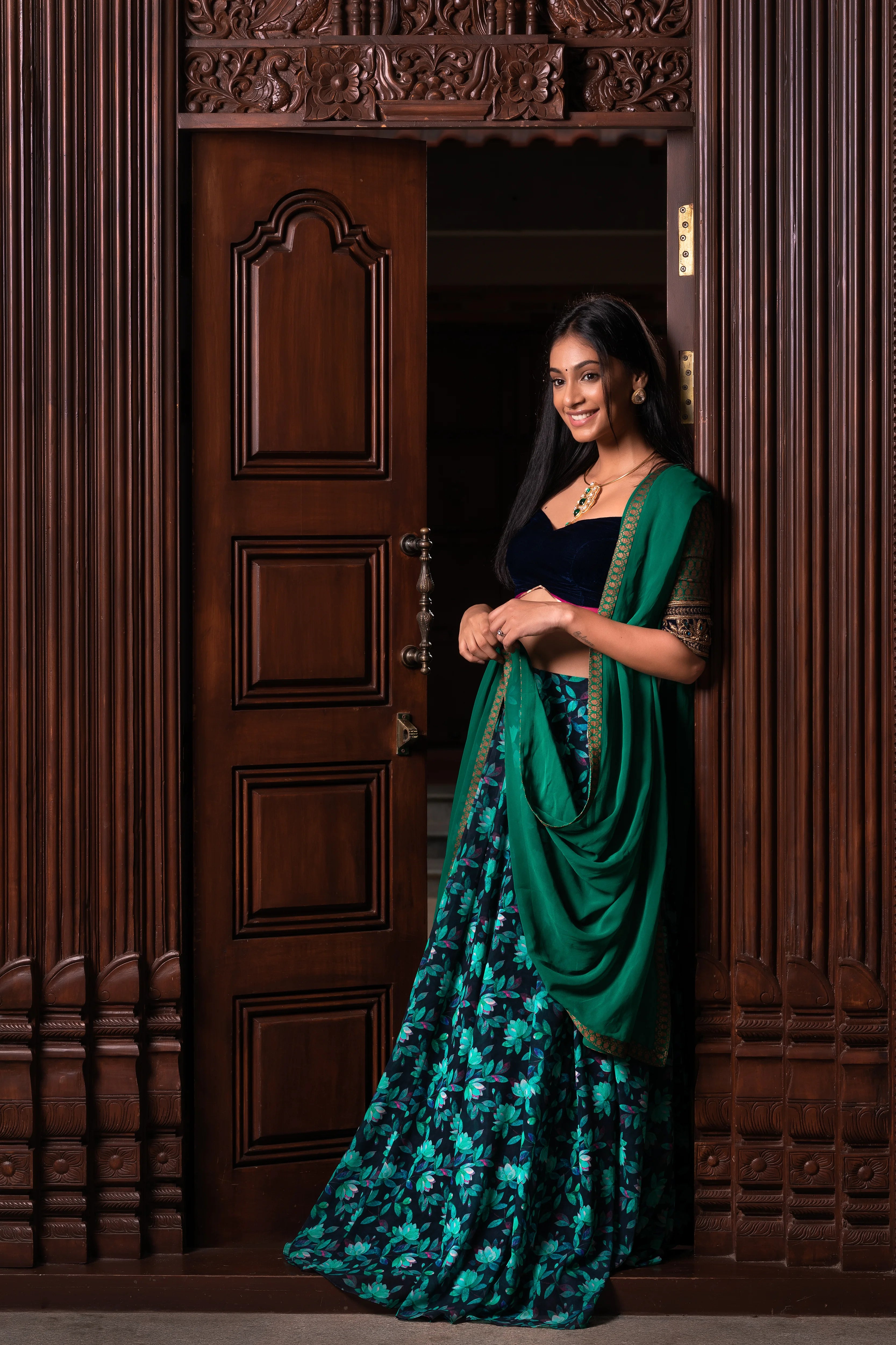 Miss India and Actress Anukreethy Vas in a blue green half saree in georgette with a brocade velvet katori cut blouse by team Archana Karthick.
