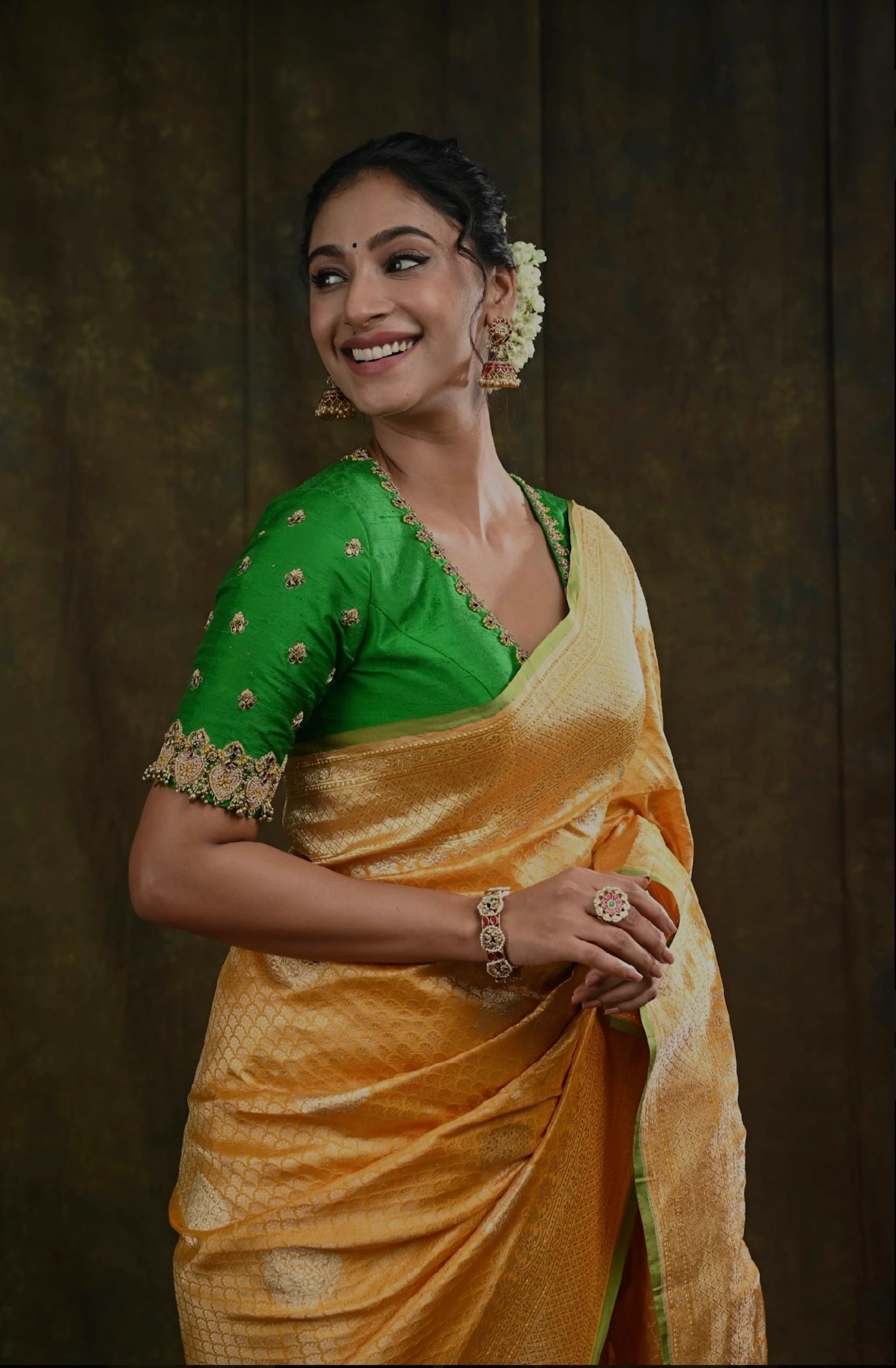 Miss India and Actress Anukreethy Vas in a green raw silk blouse, intricately handcrafted with beads, zardozi, crystals and zari knots by team Archana Karthick.