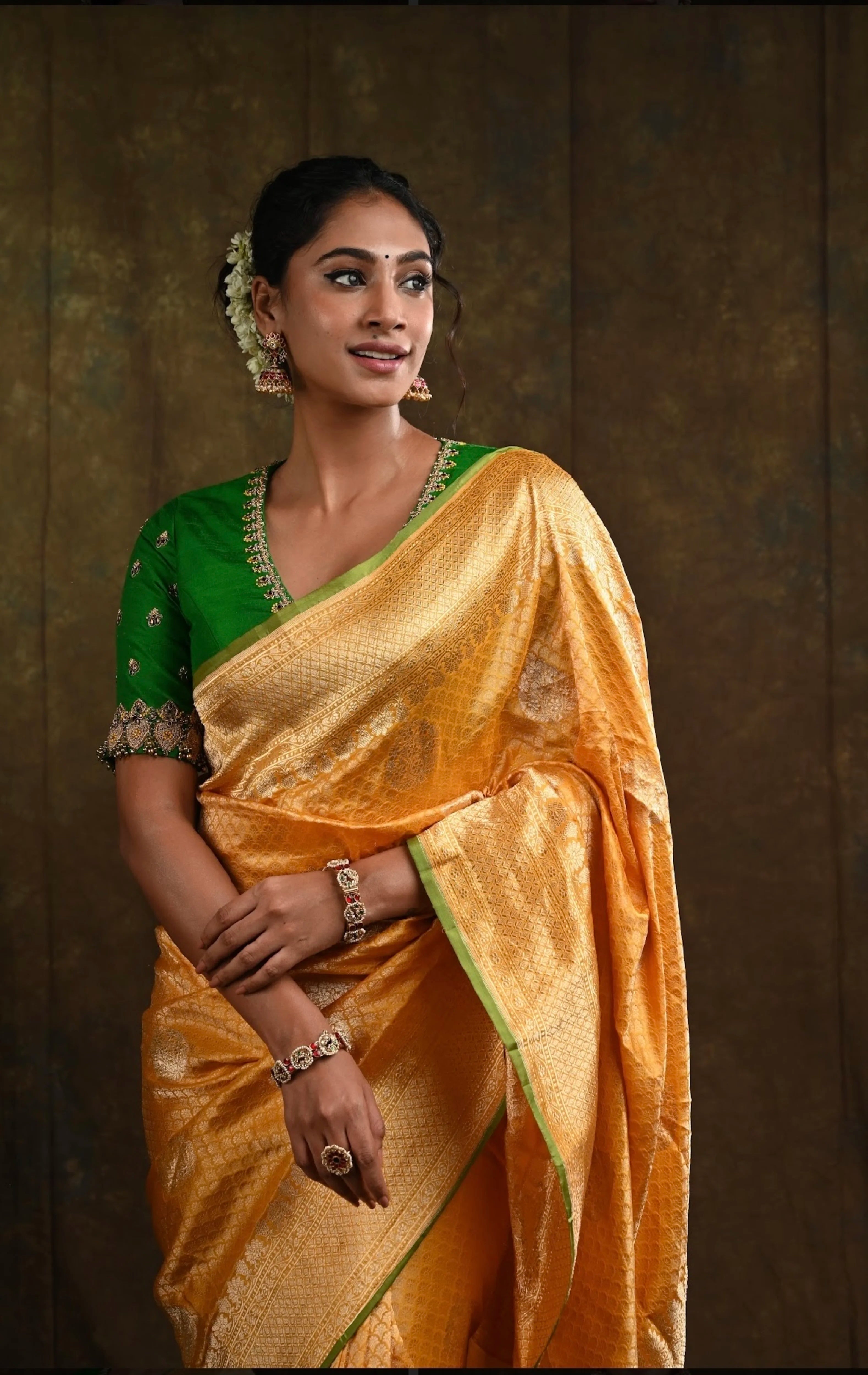 Miss India and Actress Anukreethy Vas looking left in a green raw silk blouse, intricately handcrafted with beads, zardozi, crystals and zari knots by team Archana Karthick.