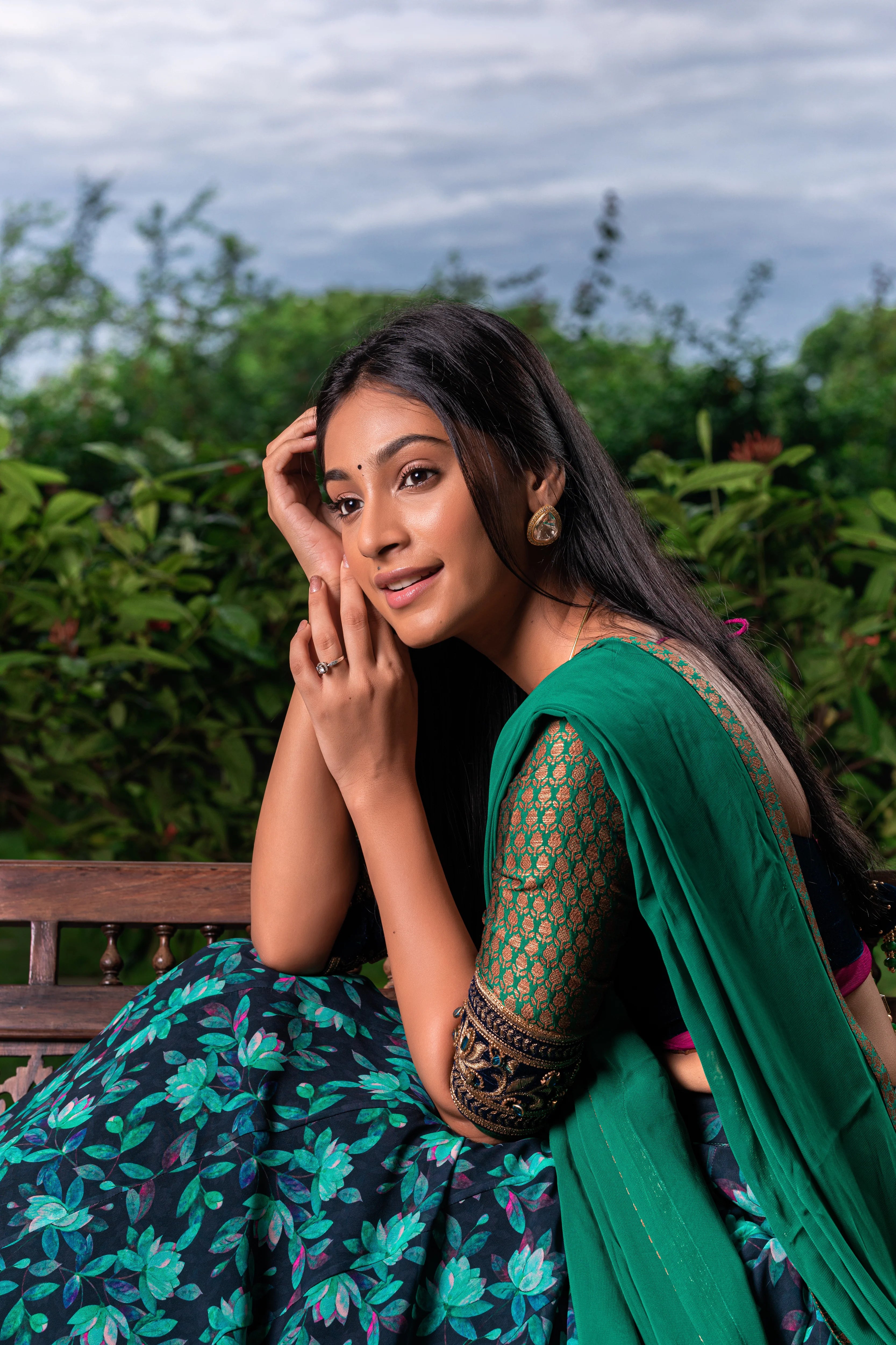 Miss India and Actress Anukreethy Vas posing in a blue green half saree in georgette with a brocade velvet katori cut blouse by team Archana Karthick.