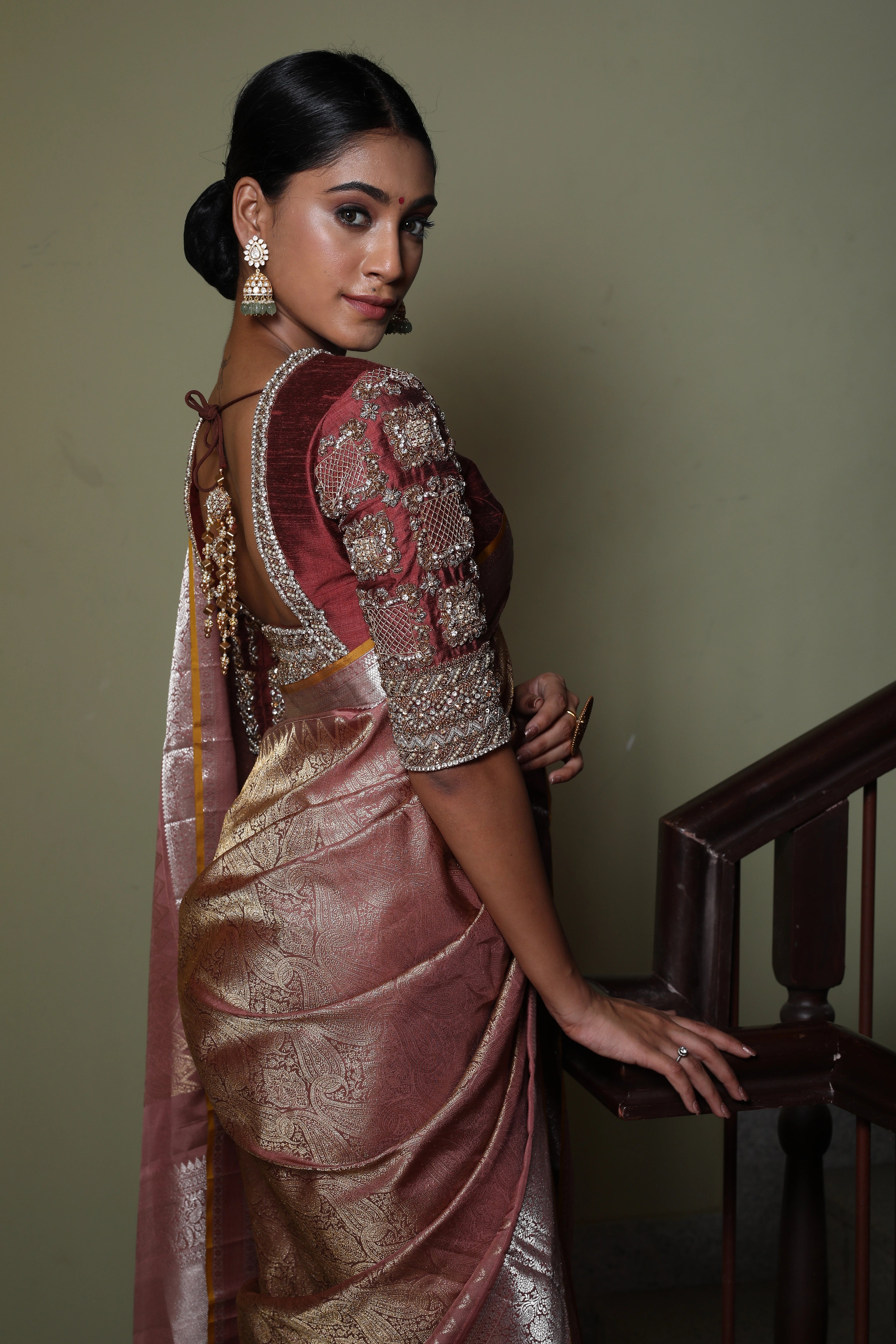Miss India and Actress Anukreethy Vas showcasing back blouse and sleeve design in a rose gold raw silk blouse, intricately handcrafted with pearls, zardozi, stones and zari by team Archana Karthick.