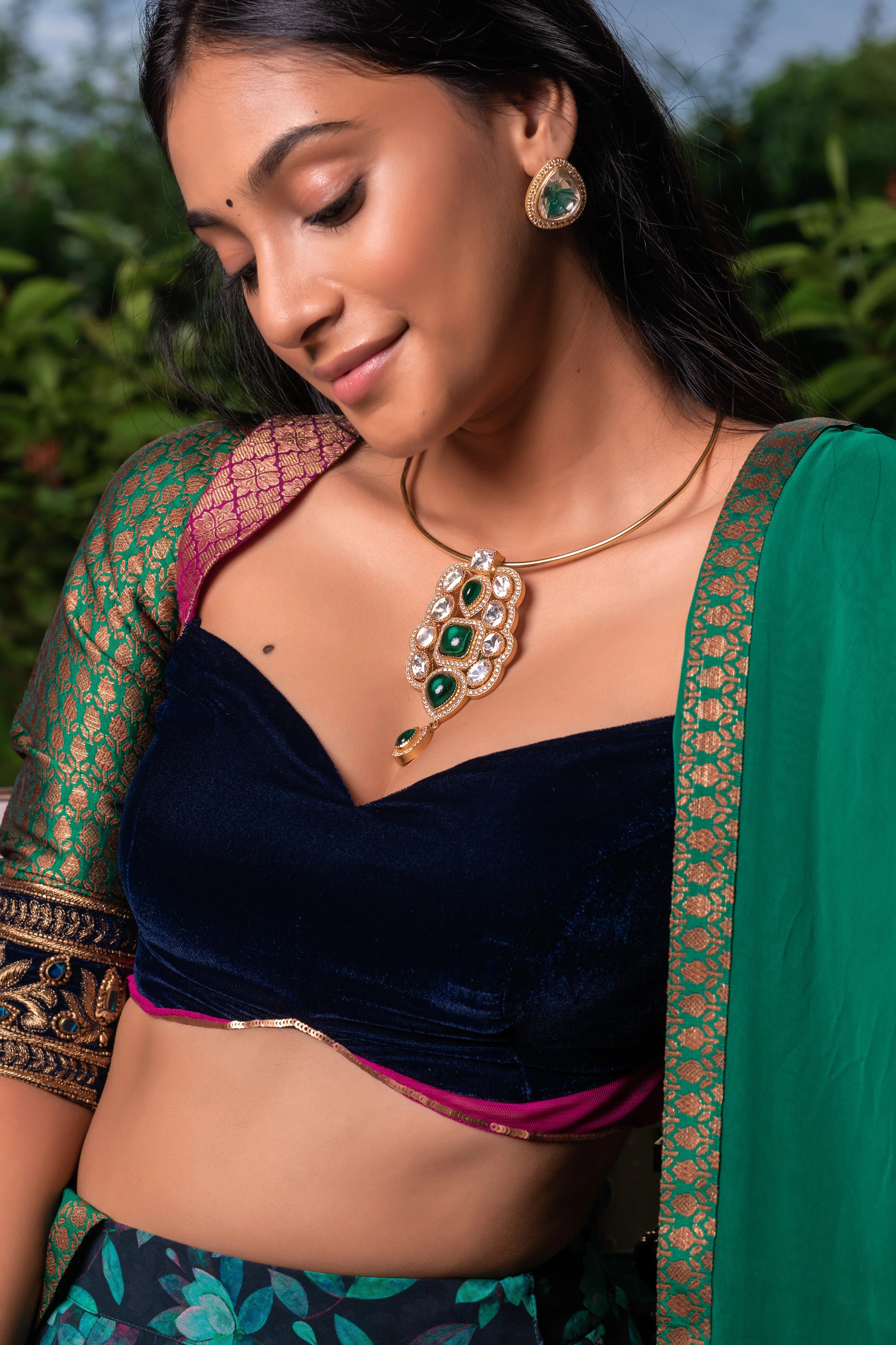 Miss India and Actress Anukreethy Vas smiling in a blue green half saree in georgette with a brocade velvet katori cut blouse by team Archana Karthick.