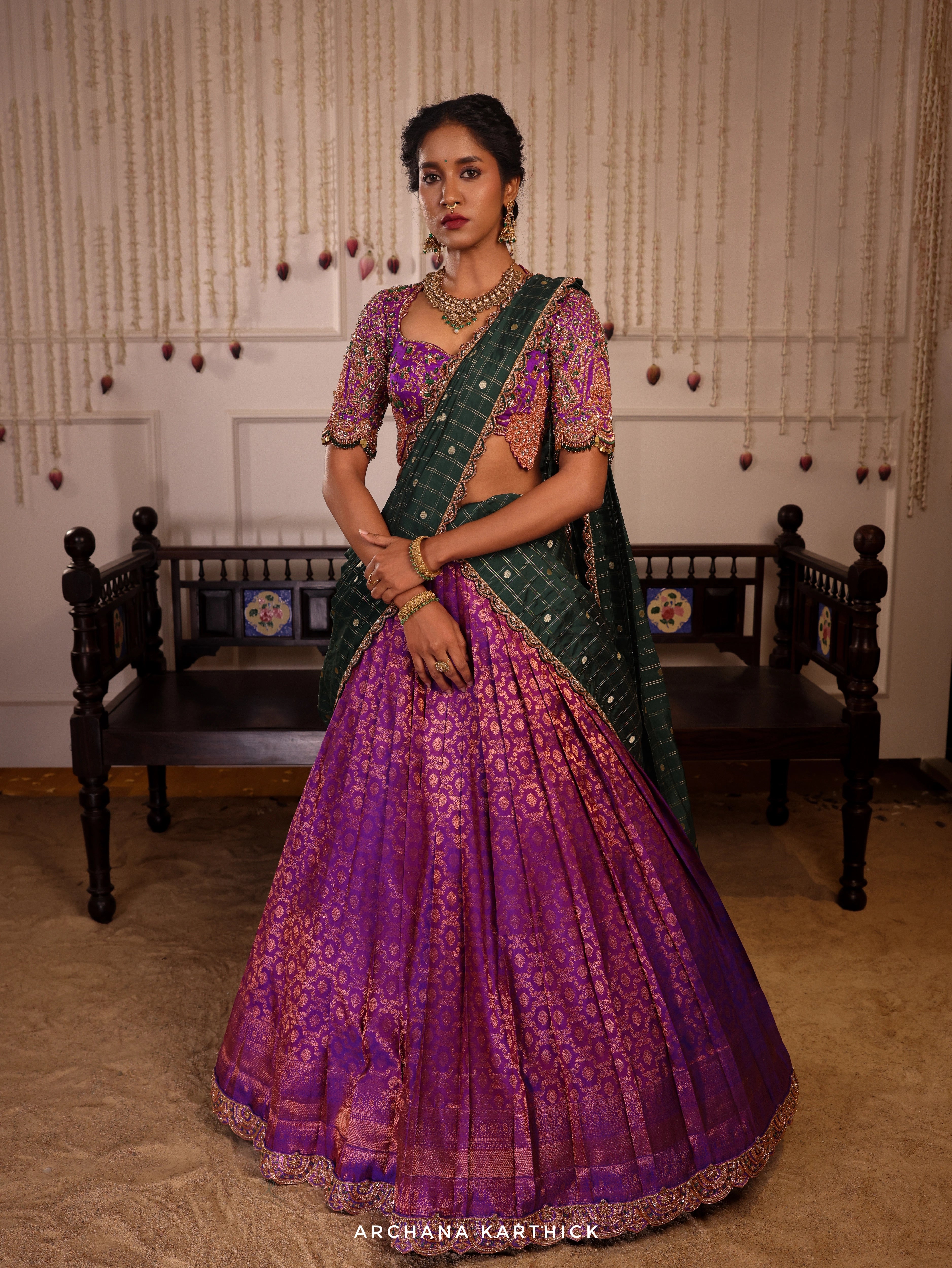 Model Gayathri Dhanasekar posing  in  purple and bottle green kanjeevaram silk half saree with jewelry by vummidi bangaru jewellers