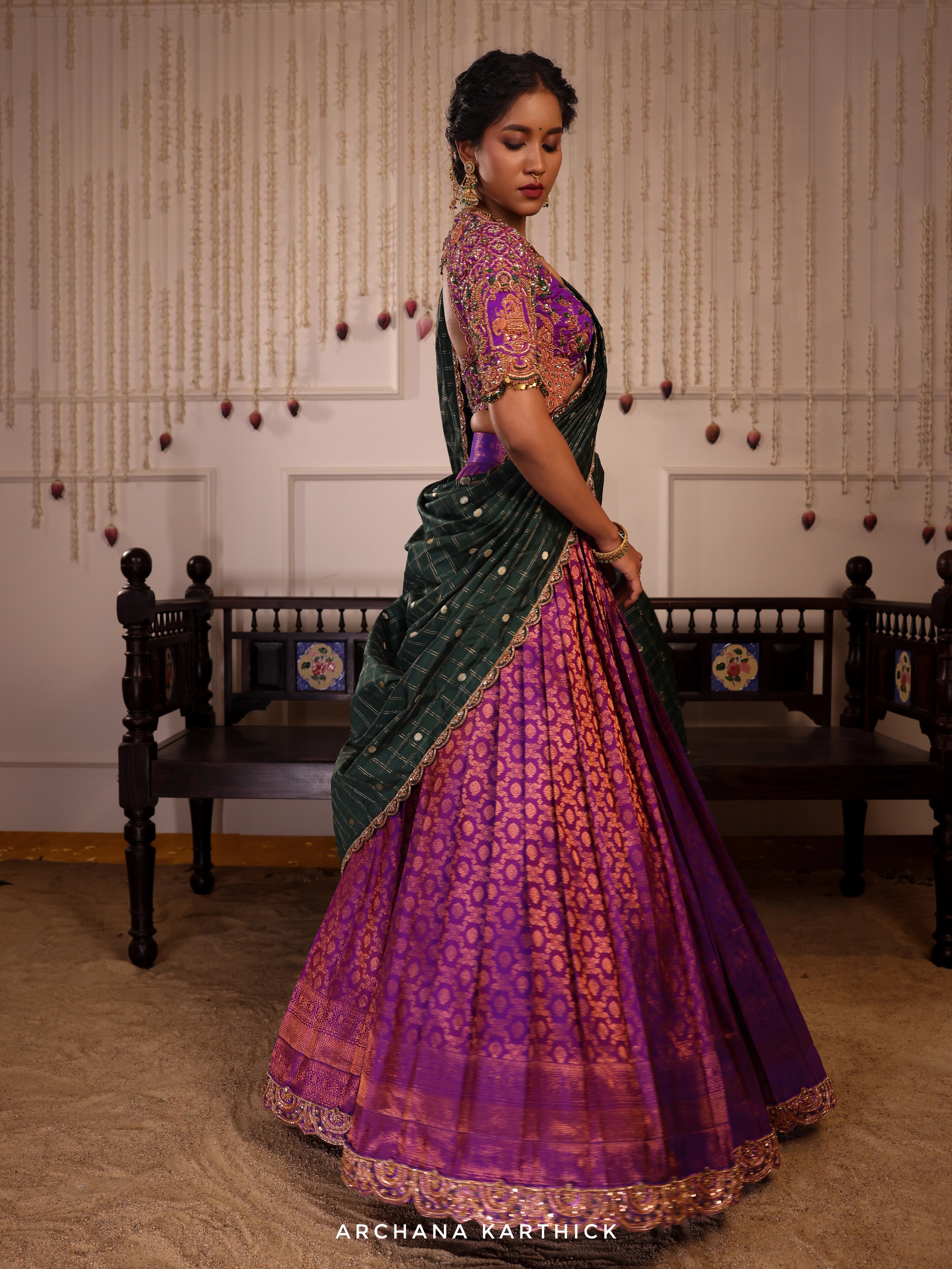 Model Gayathri Dhanasekar twirling in purple and green kanjeevaram silk half saree with vummidi bangaru jewellery