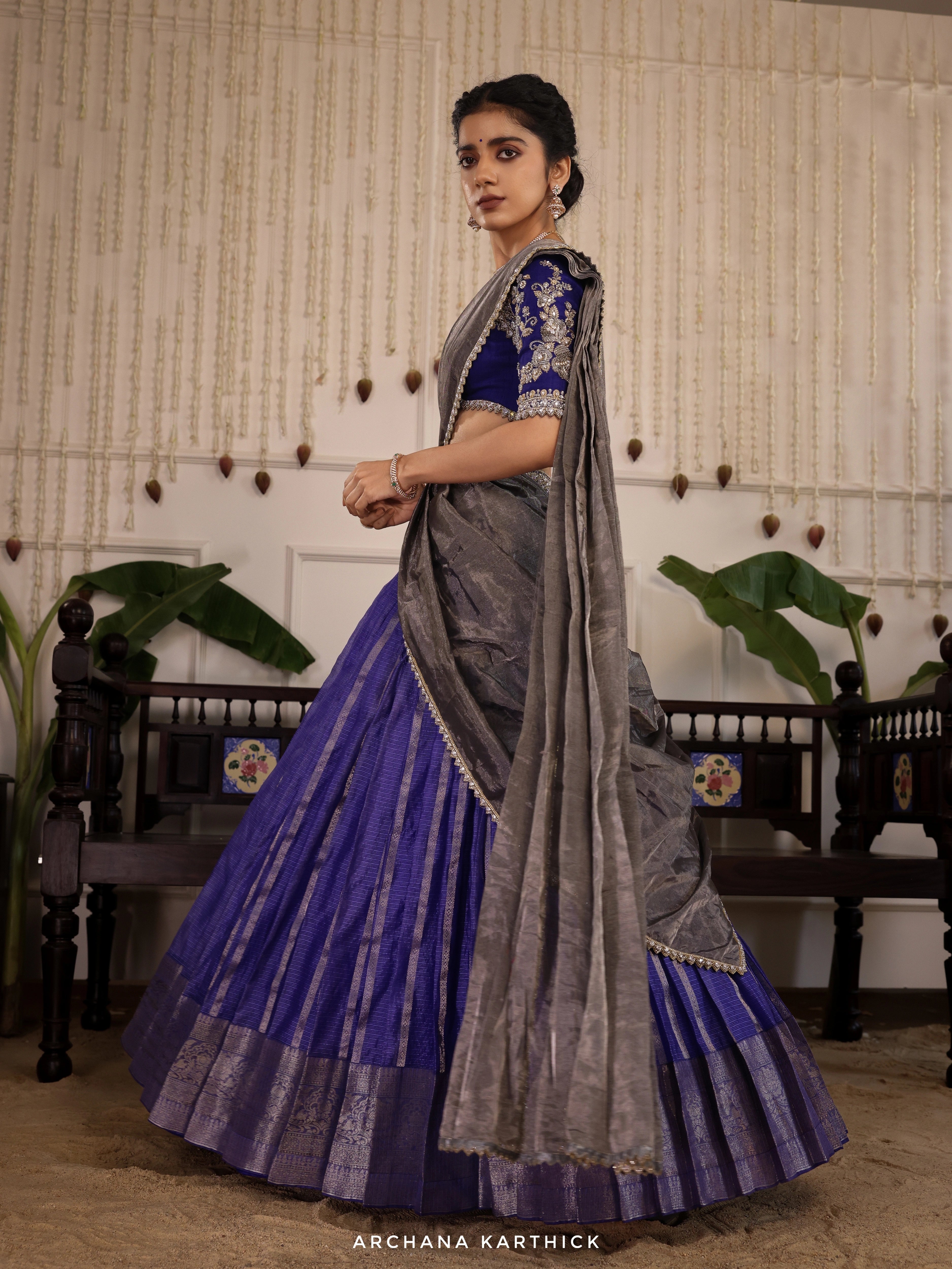 Model Himanshi poses in a blue and silver kota silk half saree with vummidi bangaru jewellers.