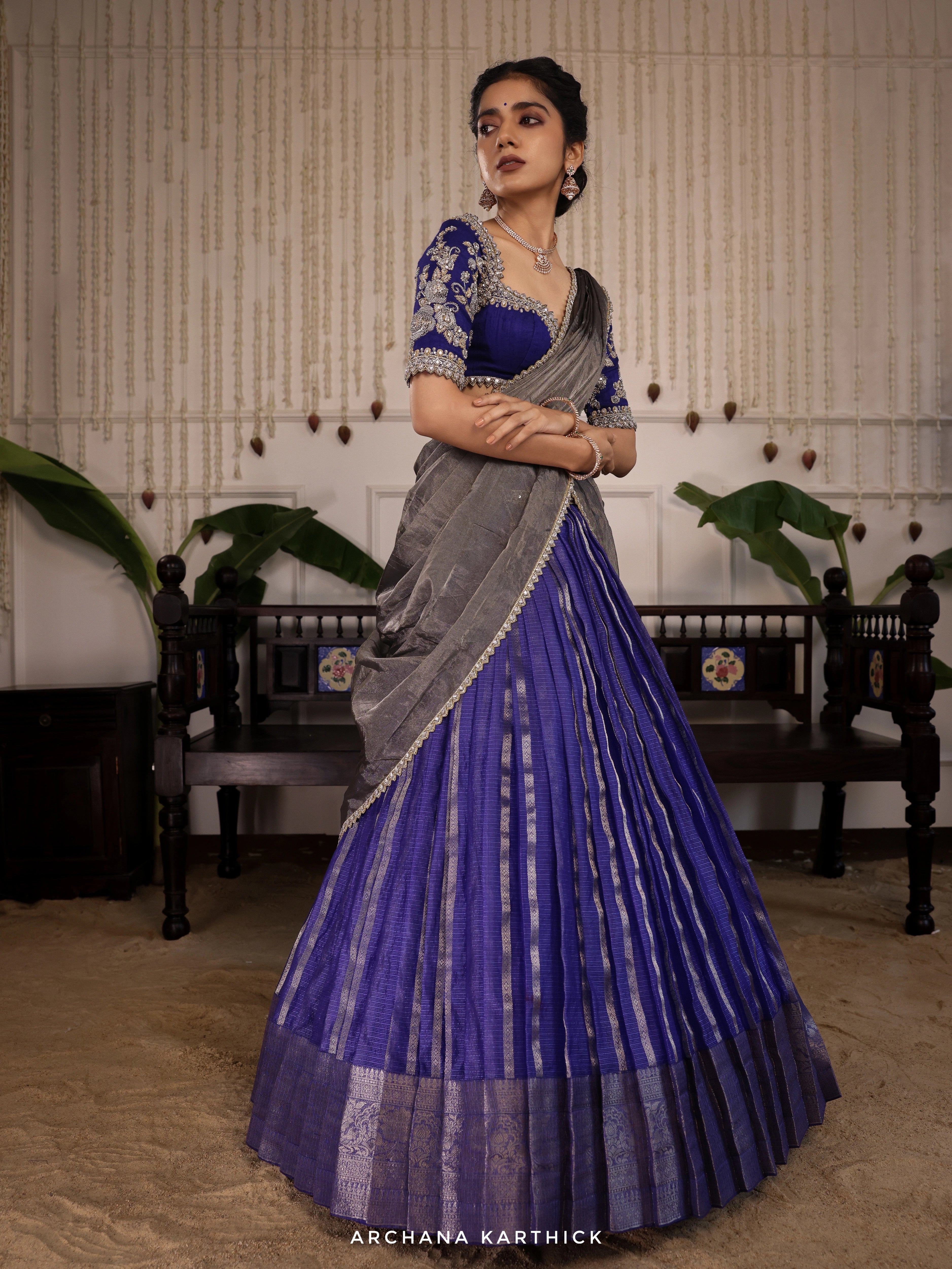Model Himanshi posing in a blue and silver kota silk half saree with vummidi bangaru jewellery