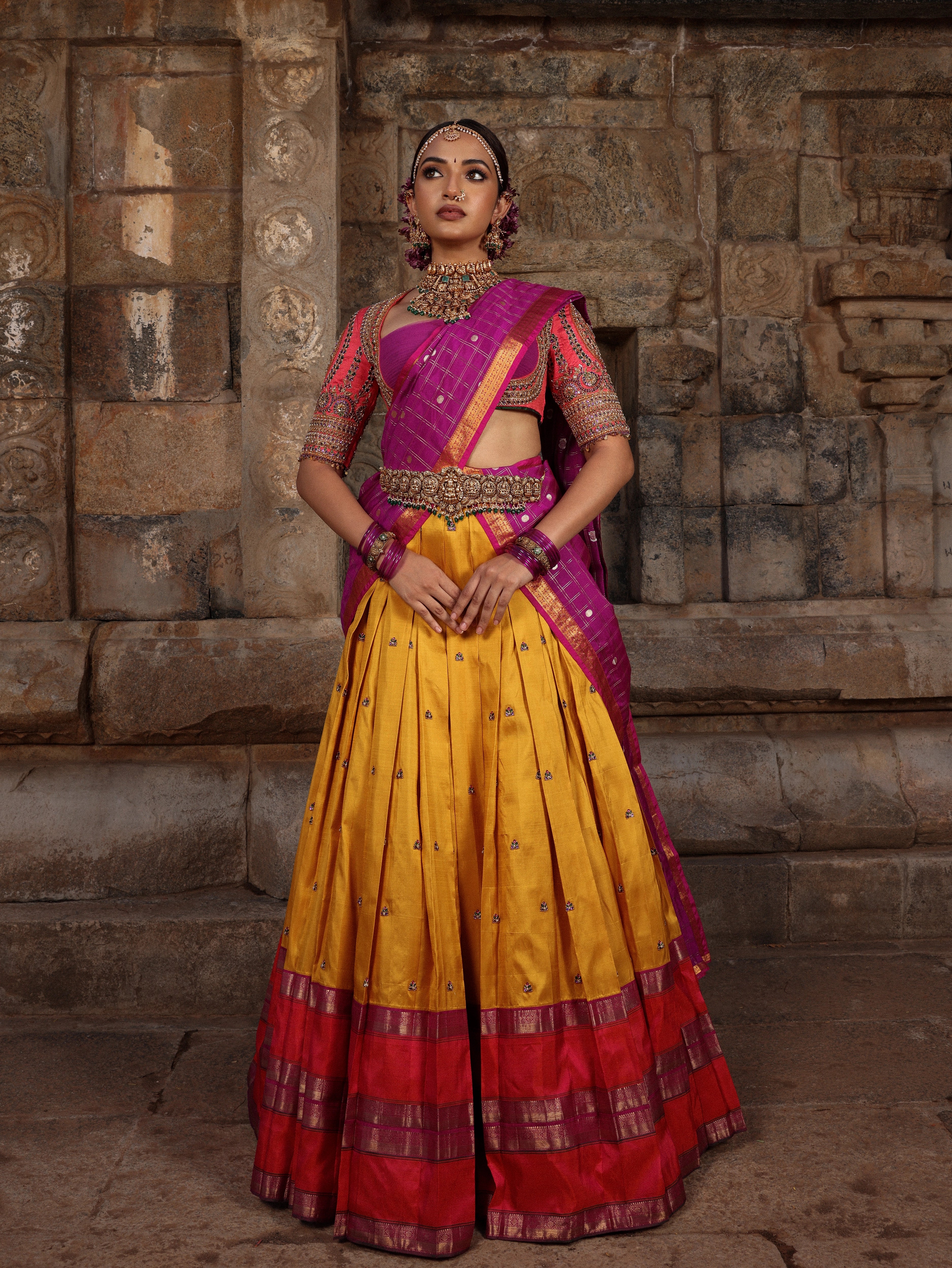 Model Anyuktha Nallani in a pink yellow and purple kanjeevaram silk half saree by chennai-based luxury couture label Archana Karthick