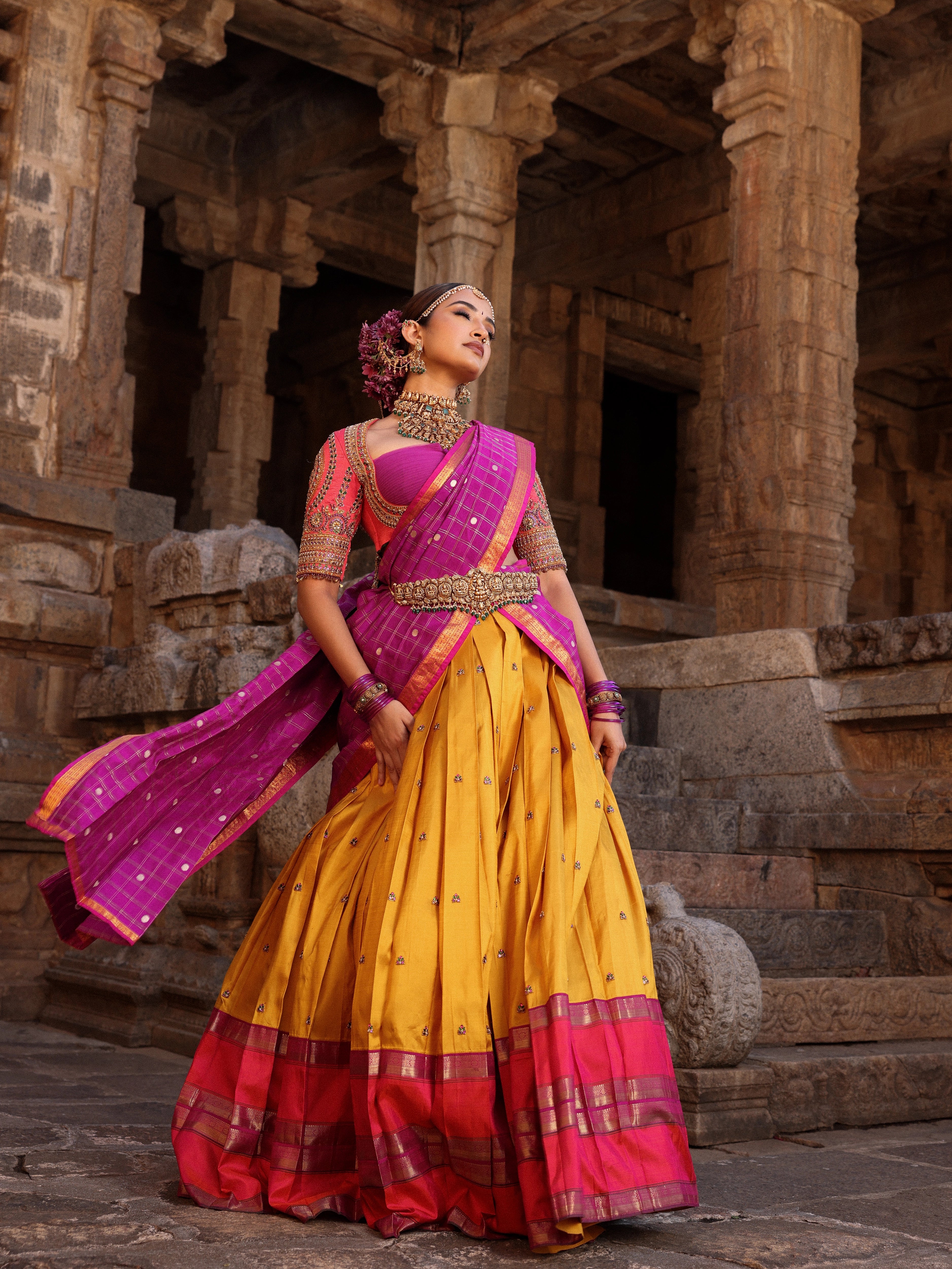 Model Anyuktha Nallani in pink yellow and purple kanjeevaram silk half saree by chennai-based luxury couture label Archana Karthick
