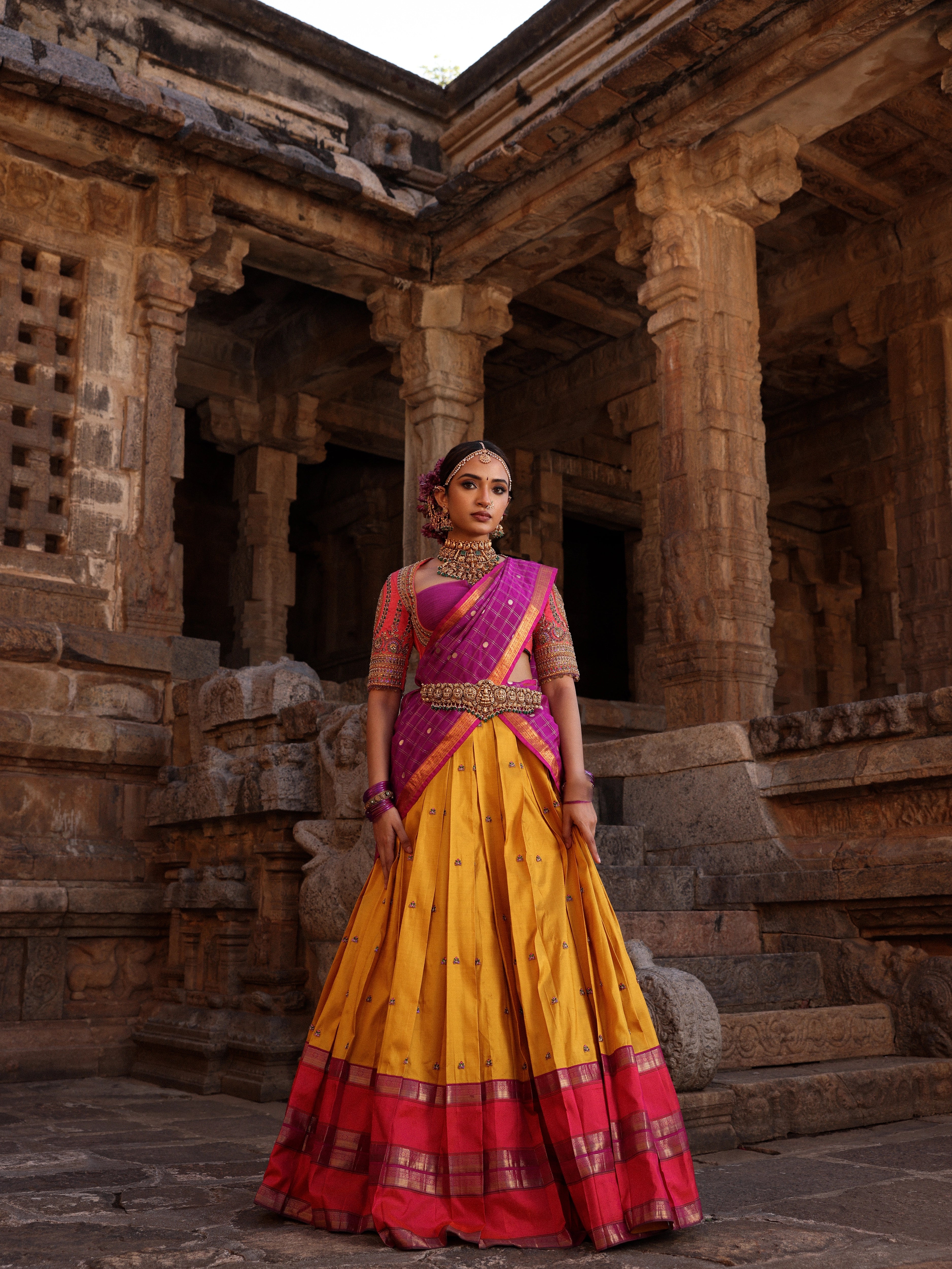 Model Anyuktha Nallani posing during campaign shoot in pink yellow and purple kanjeevaram silk half saree by chennai-based luxury couture label Archana Karthick