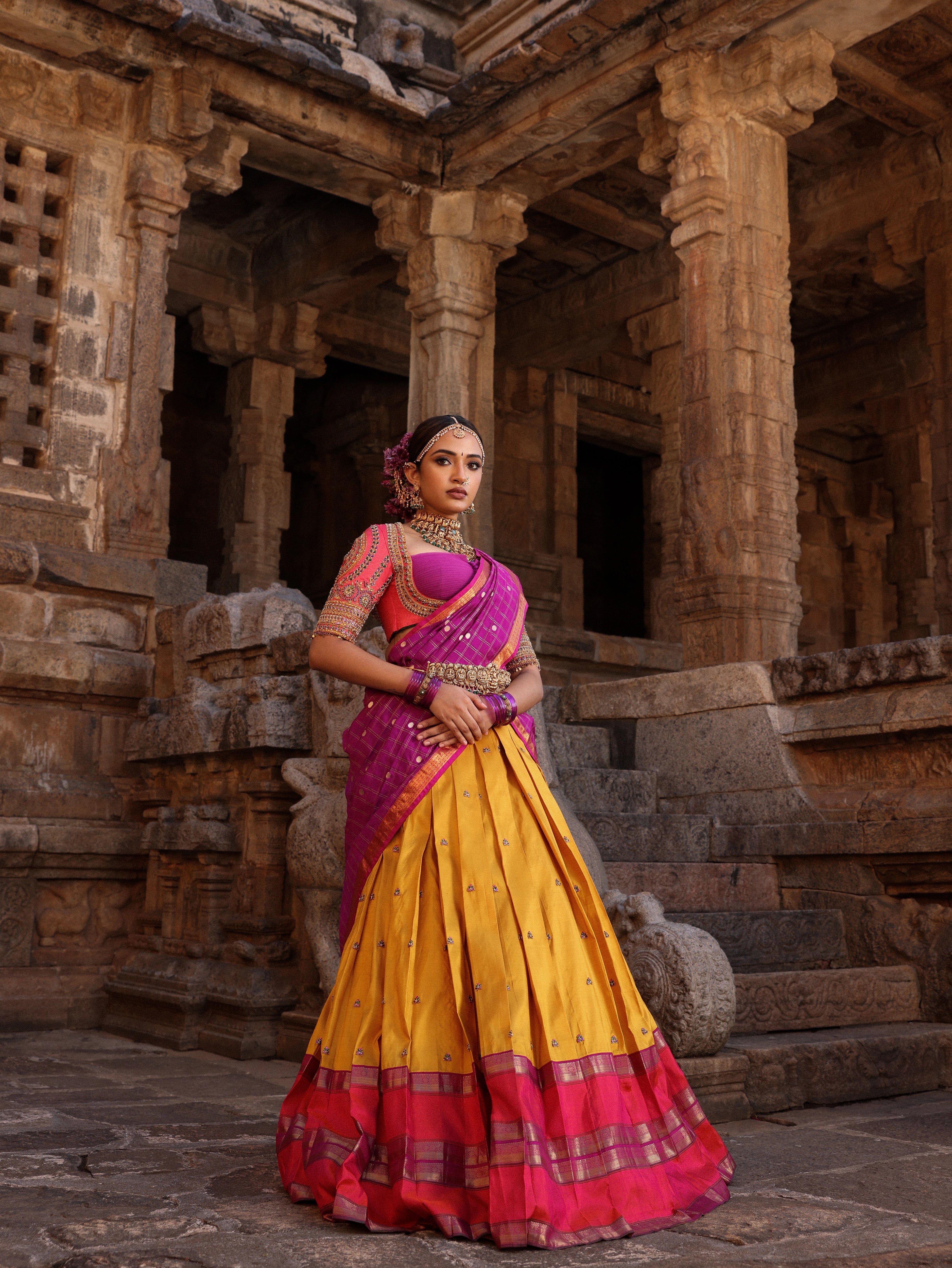 Model Anyuktha Nallani posing during photoshoot in pink yellow and purple kanjeevaram silk half saree by chennai-based luxury couture label Archana Karthick