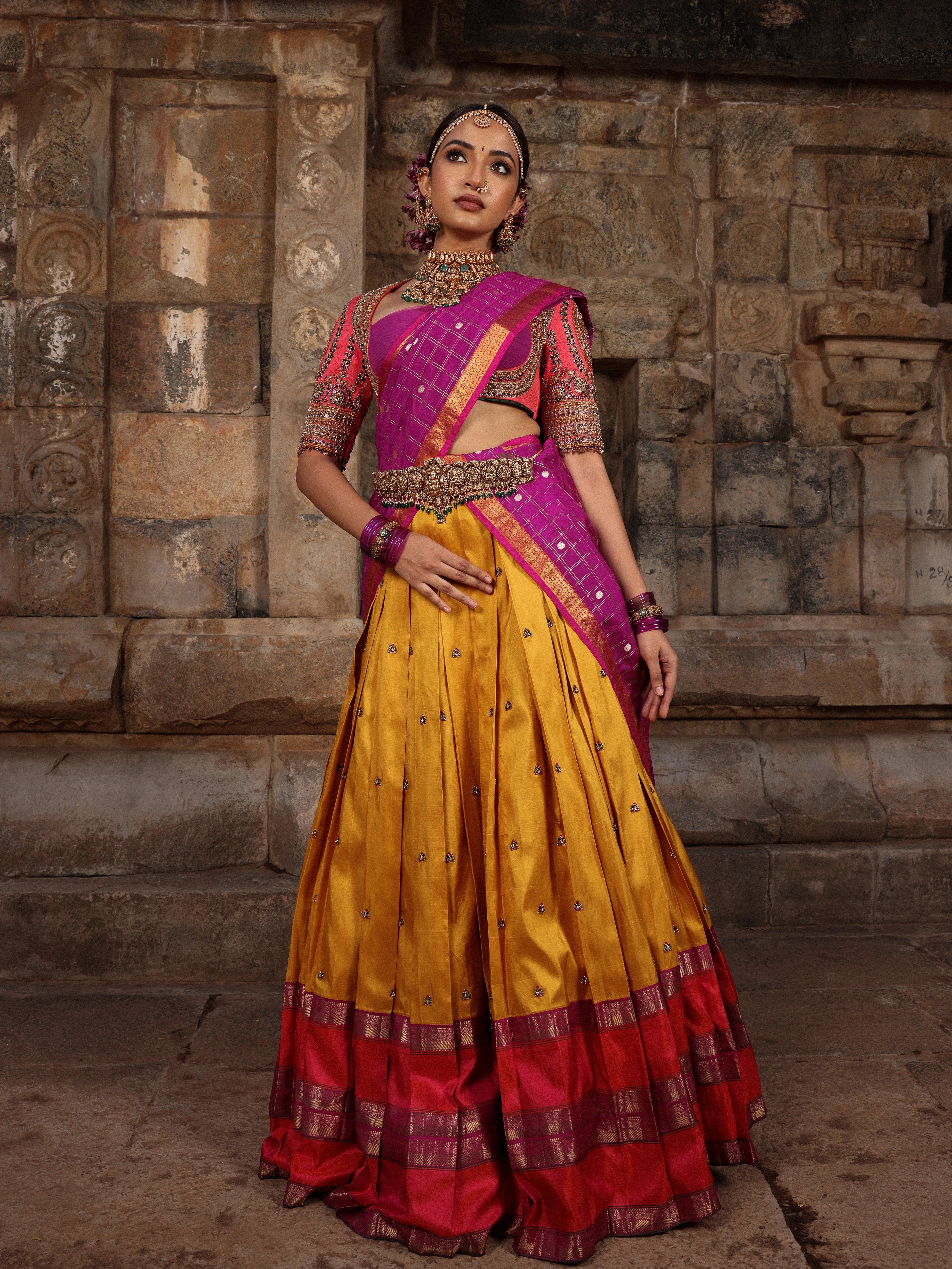Model Anyuktha Nallani posing during shoot in pink yellow and purple kanjeevaram silk half saree by chennai-based luxury couture label Archana Karthick
