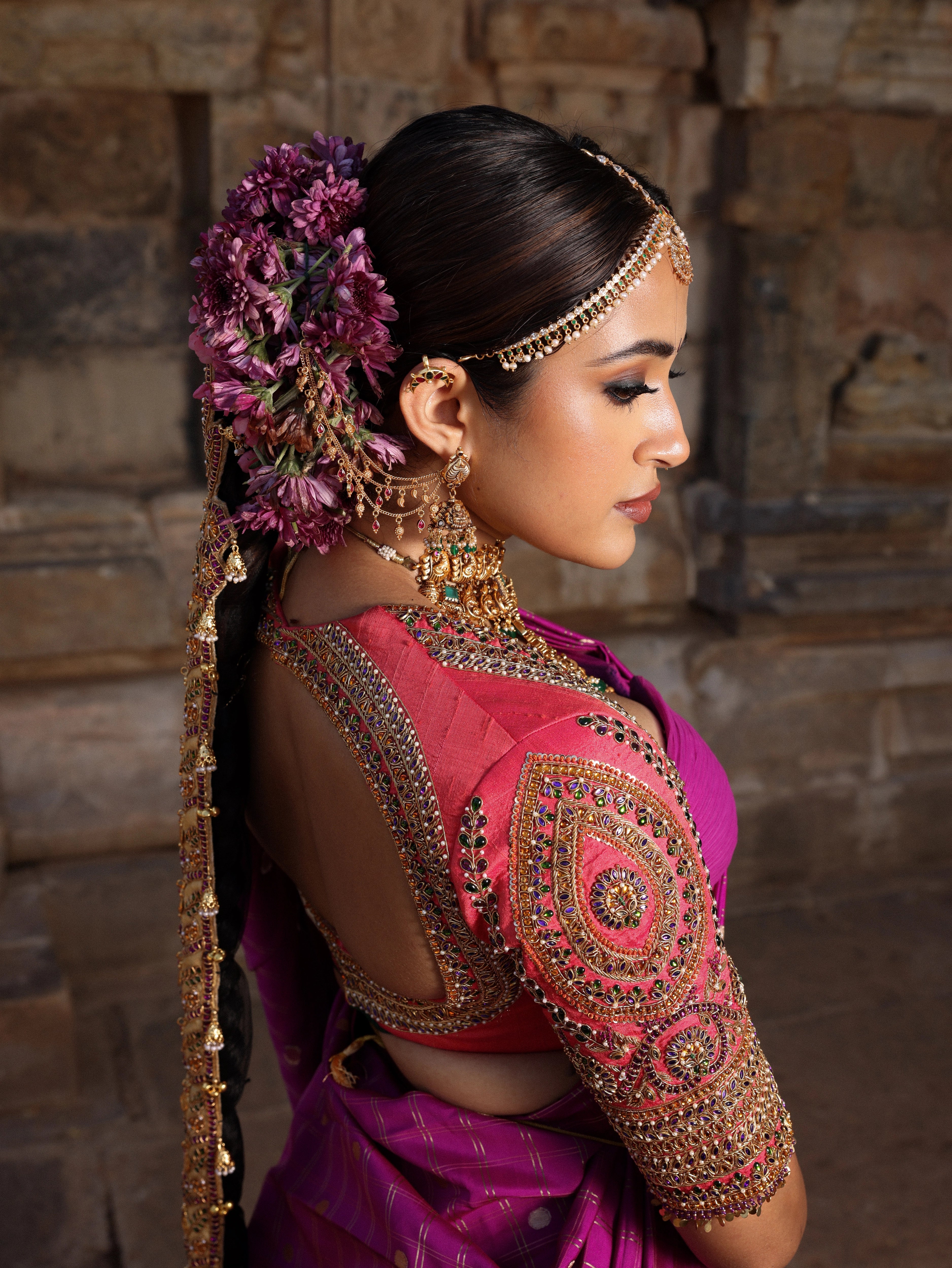 Model Anyuktha Nallani showcasing blouse back design in pink yellow and purple kanjeevaram silk half saree by chennai-based luxury couture label Archana Karthick
