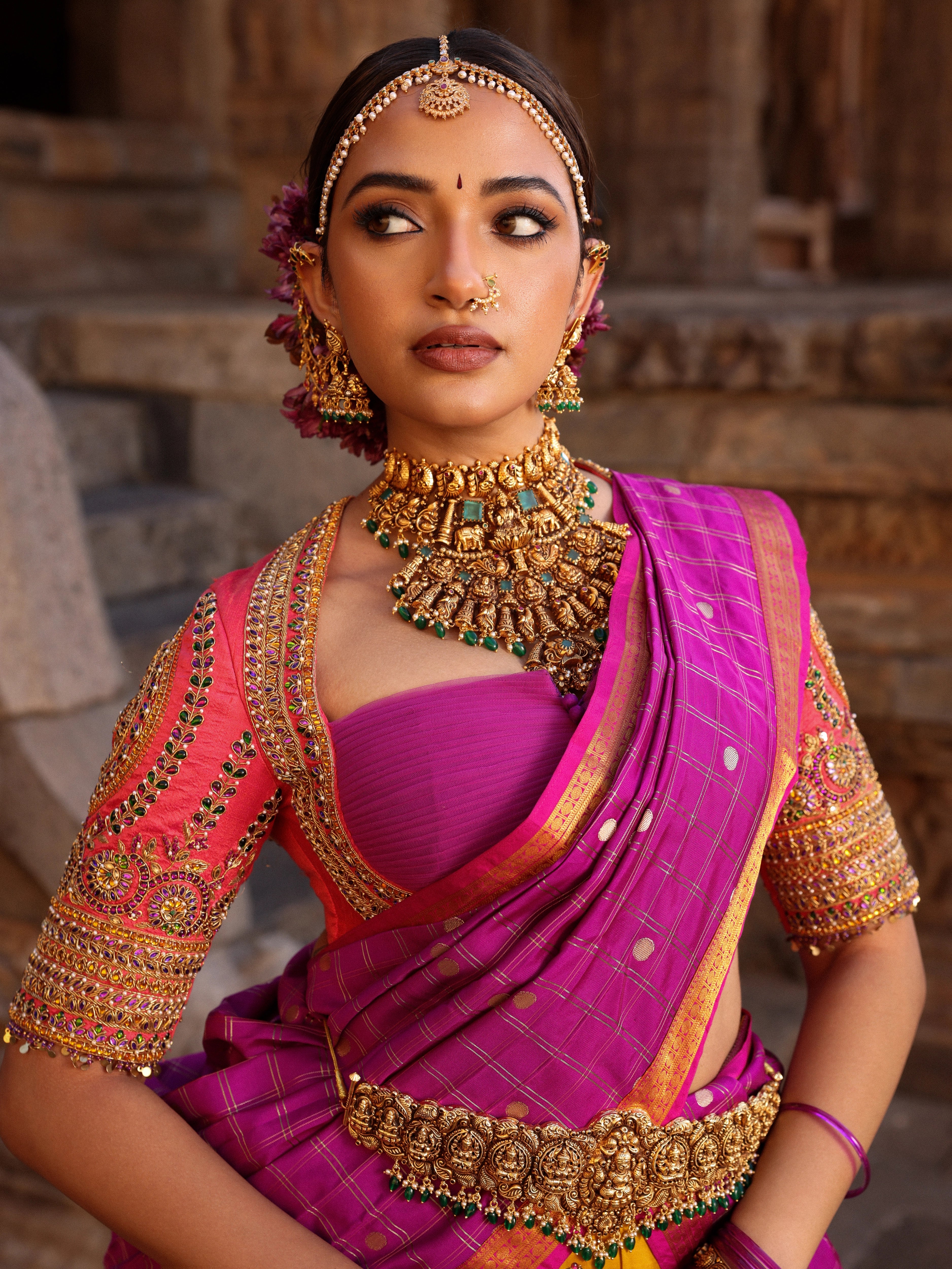 Model Anyuktha Nallani showcasing blouse design in pink yellow and purple kanjeevaram silk half saree by chennai-based luxury couture label Archana Karthick
