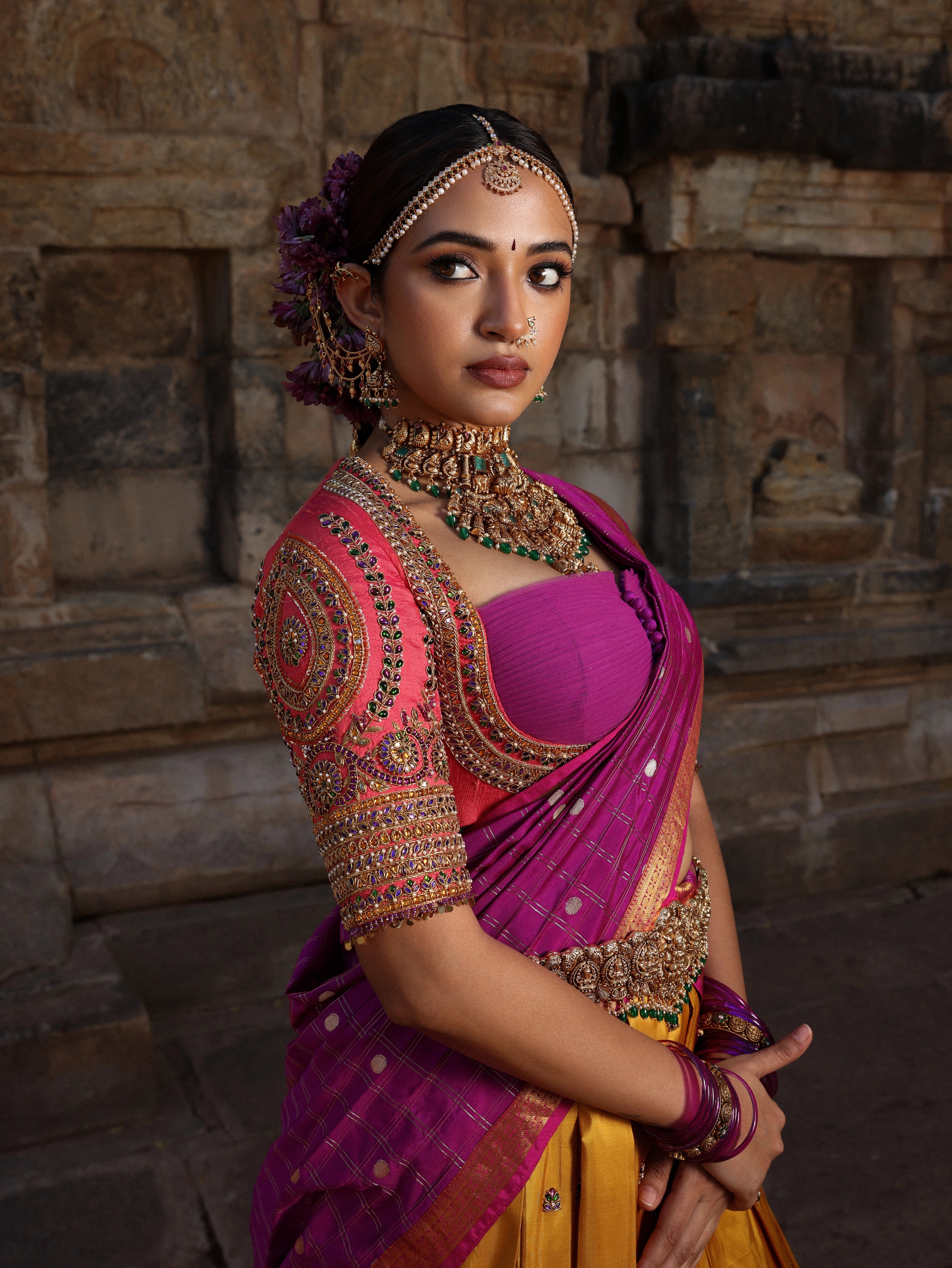 Model Anyuktha Nallani showcasing blouse detailing in pink yellow and purple kanjeevaram silk half saree by chennai-based luxury couture label Archana Karthick