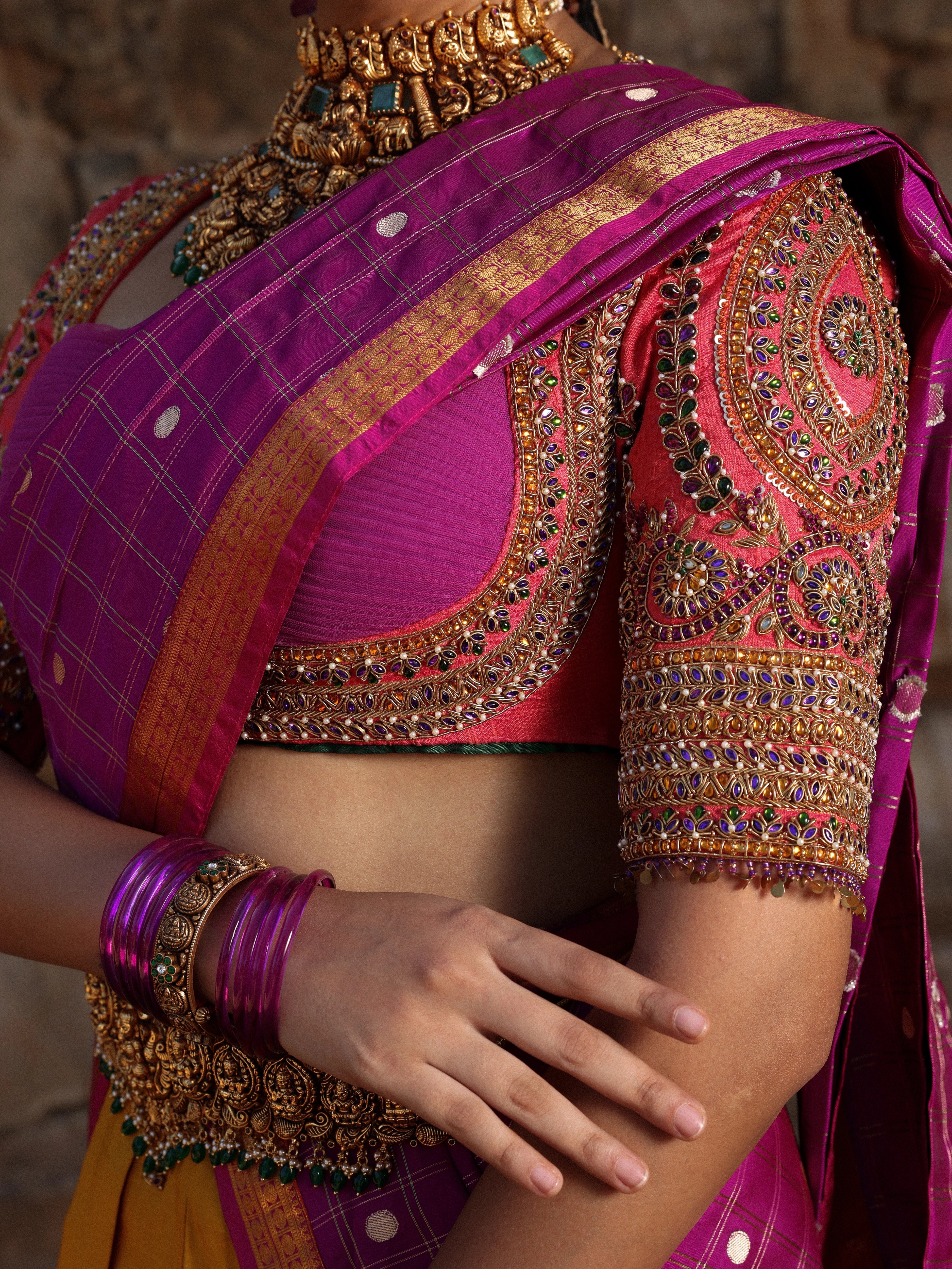 Model Anyuktha Nallani showcasing sleeve & cup design in pink yellow and purple kanjeevaram silk half saree by chennai-based luxury couture label Archana Karthick