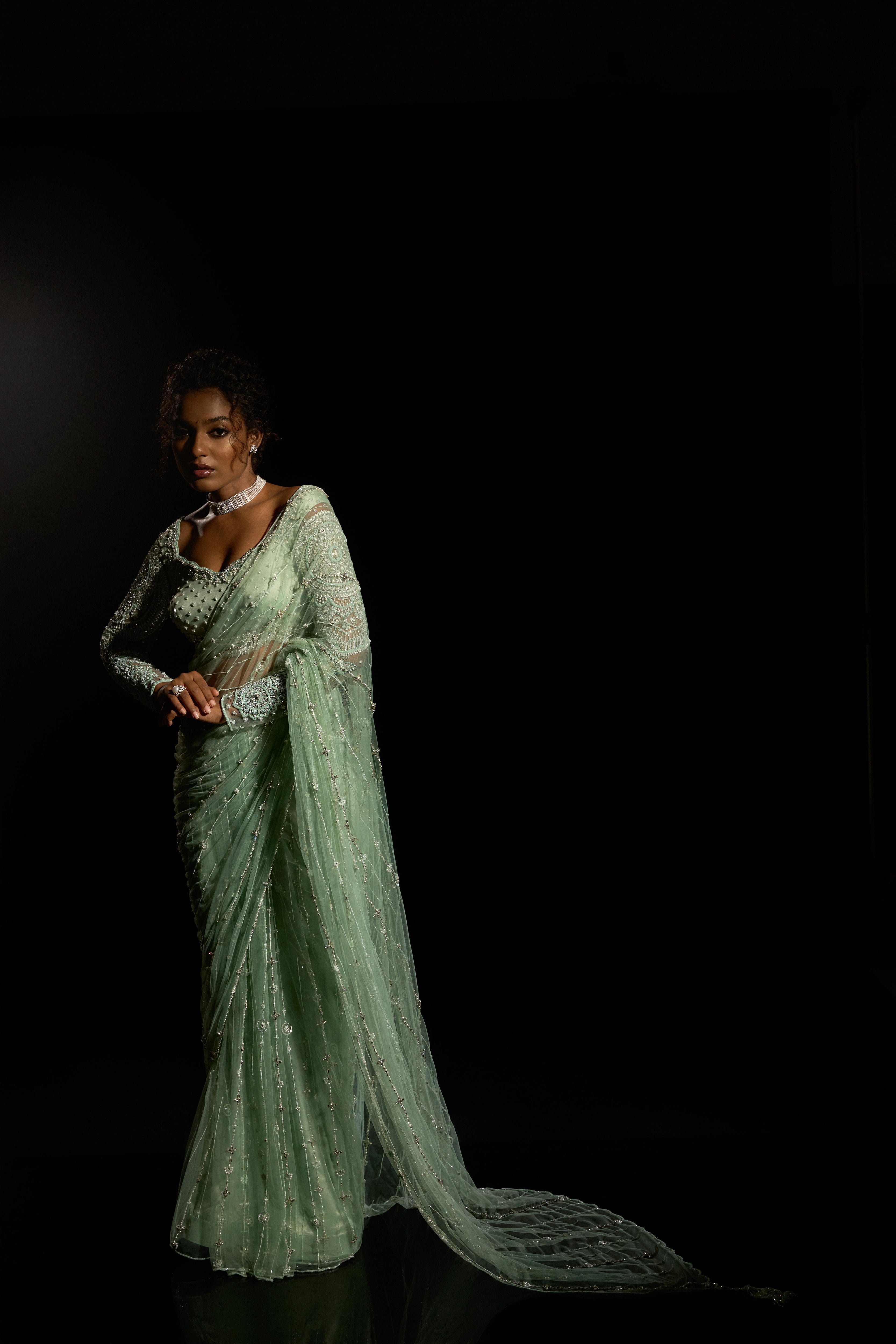 Model Ashika Crystal posing for a photoshoot in a green saree set intricately adorned with sequins, rhinestones, crystals and cutdana for "STARDUST" - A/W'25 saree collection by team Archana Karthick.