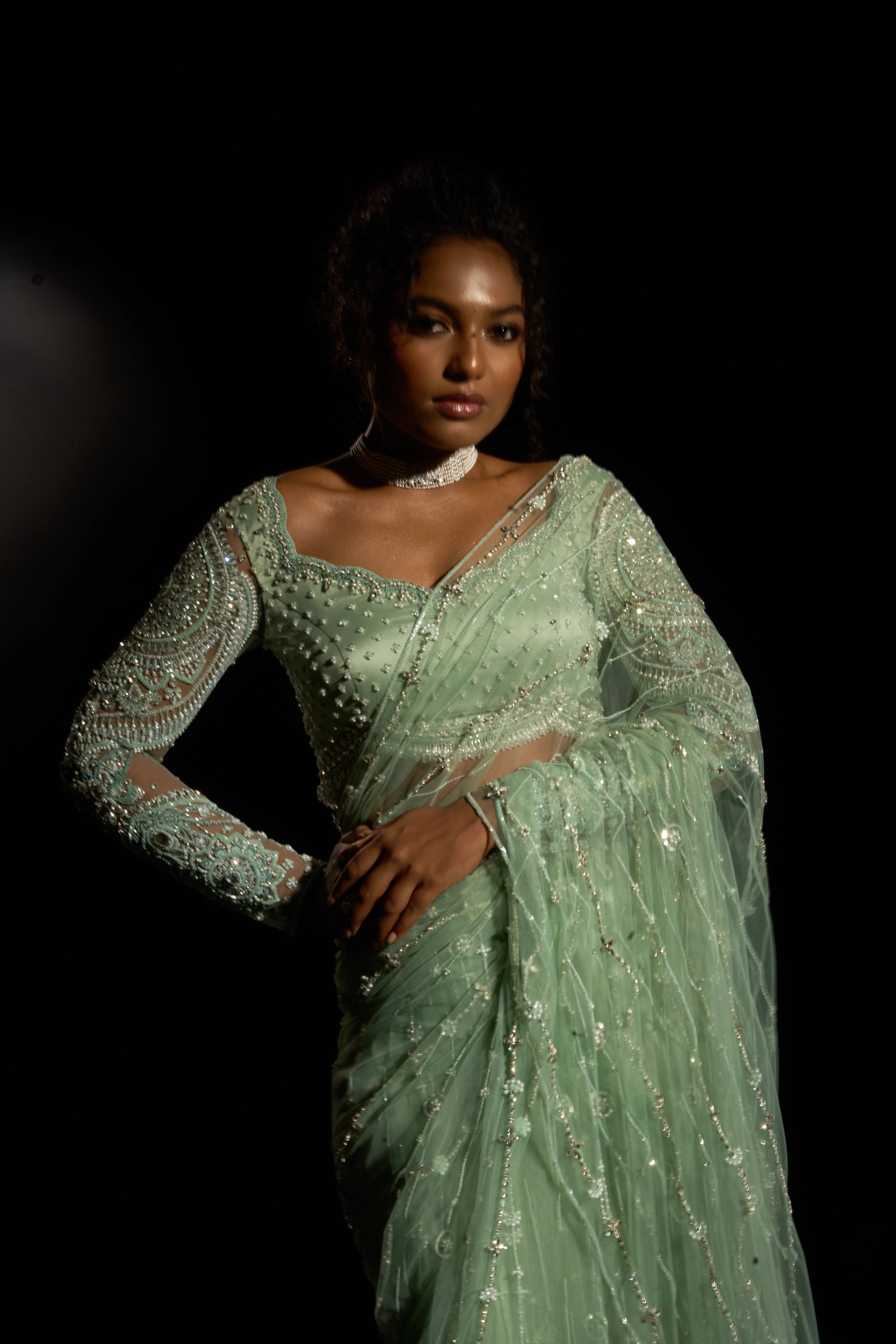 Model Ashika Crystal posing forfront detailing in a green saree set intricately adorned with sequins, rhinestones, crystals and cutdana for "STARDUST" - A/W'25 saree collection by team Archana Karthick.