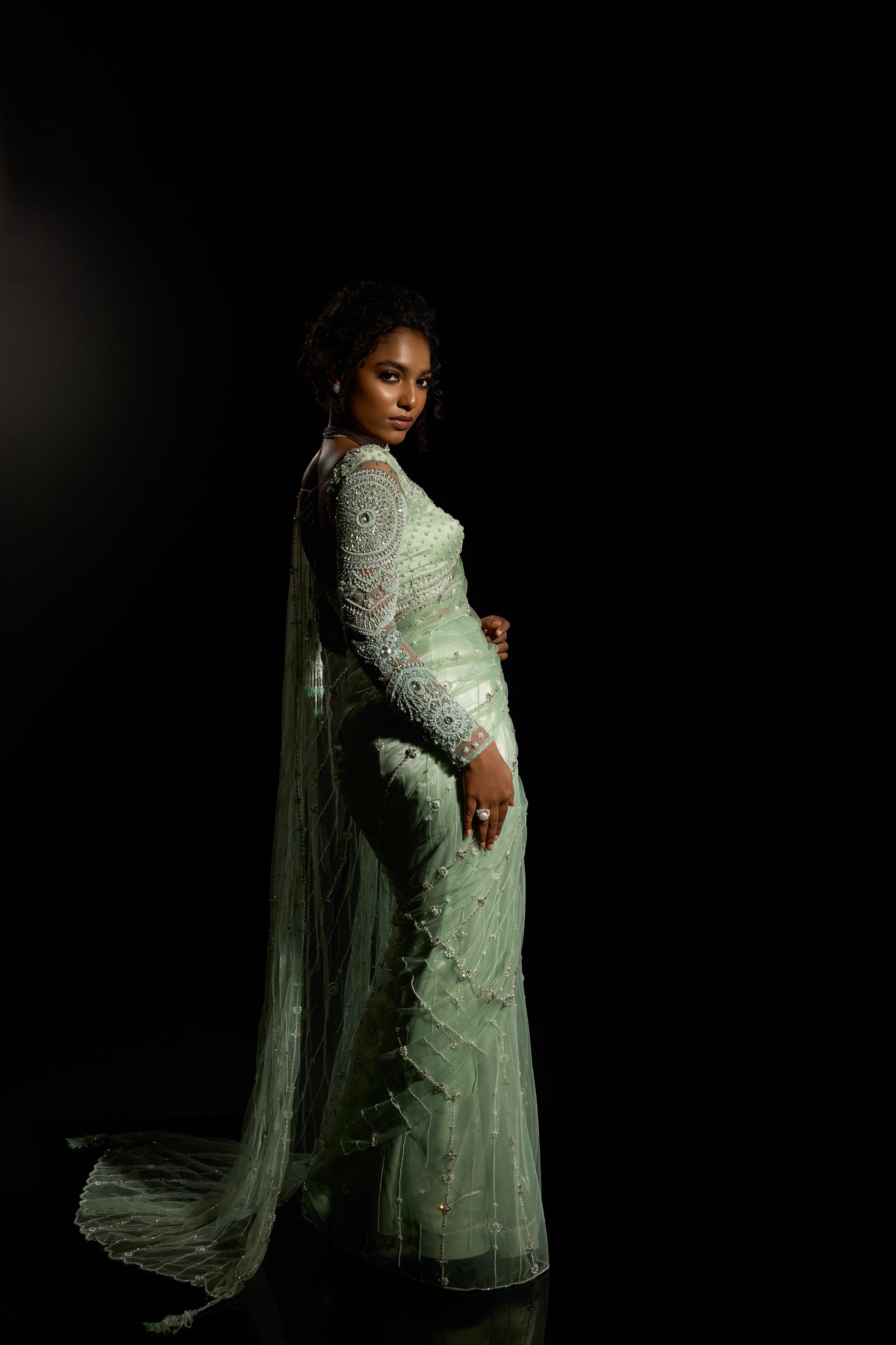 Model Ashika Crystal posing in a green saree set intricately adorned with sequins, rhinestones, crystals and cutdana for "STARDUST" - A/W'25 saree collection by team Archana Karthick.