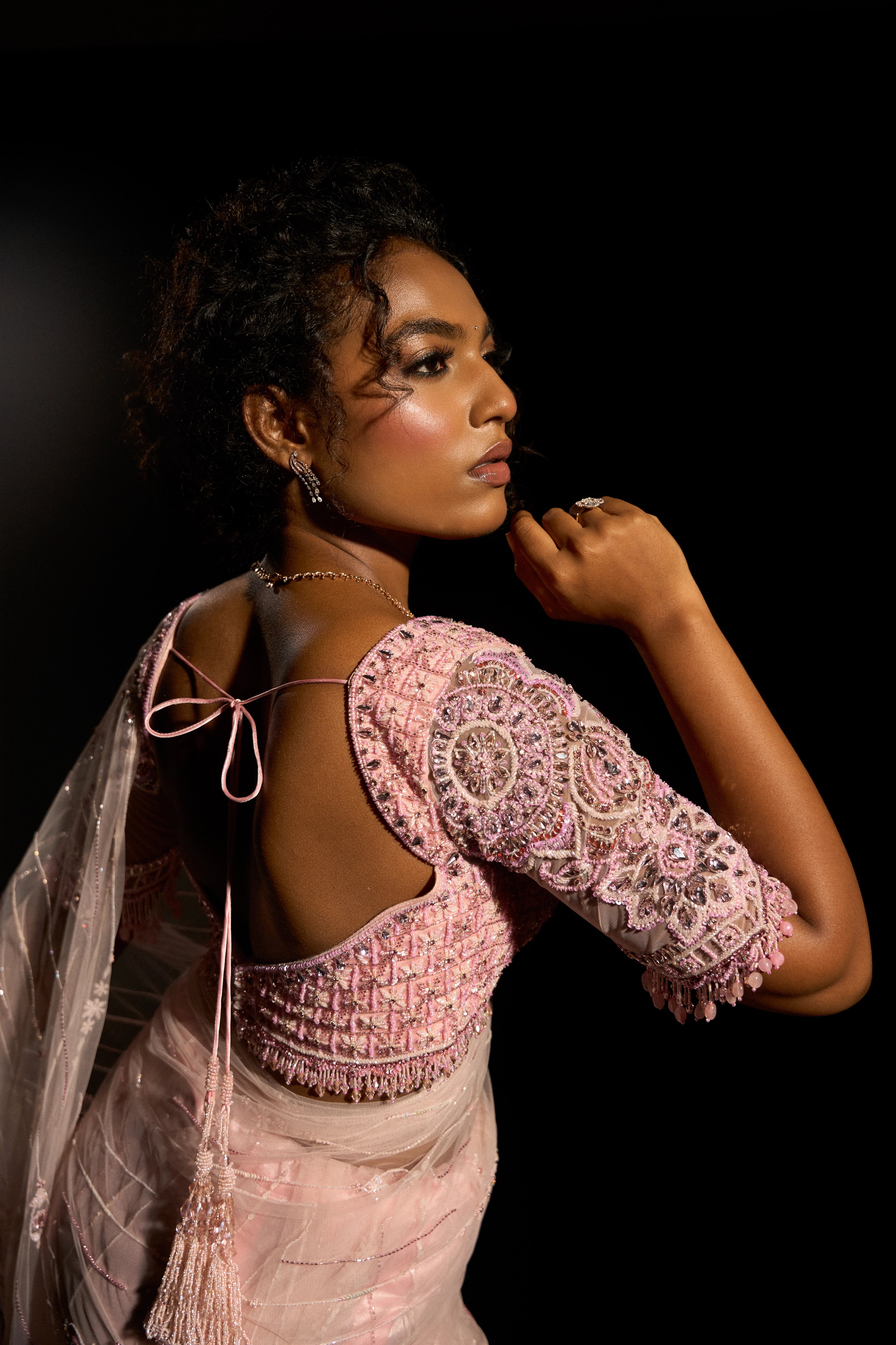 Model Ashika Crystal showcasing back and sleeve detailing in a blush pink saree set, intricately adorned with sequins, rhinestones, crystals and cutdana for "STARDUST" - A/W'25 saree collection by team Archana Karthick.