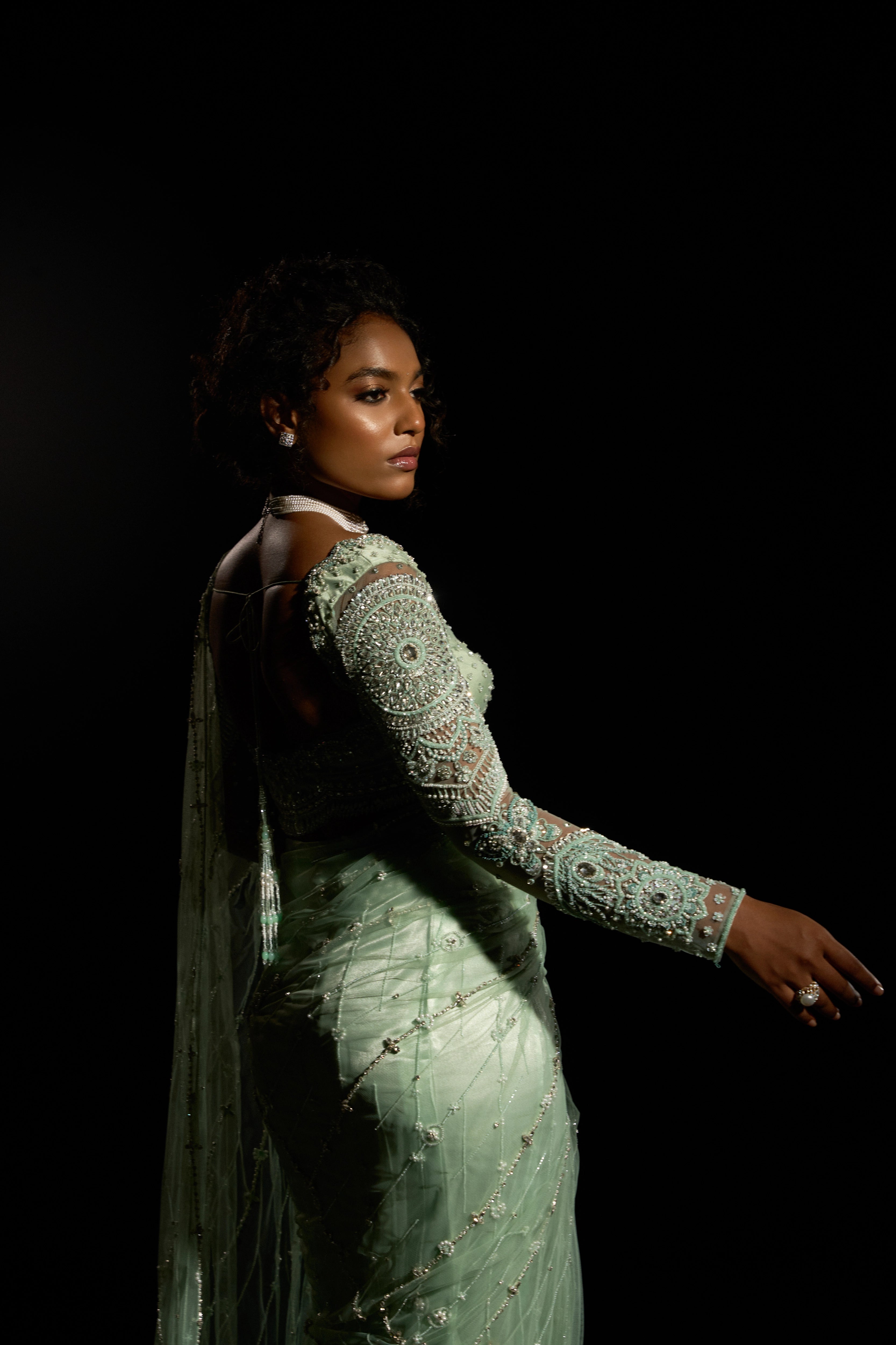 Model Ashika Crystal showcasing the sleeve in a green saree set intricately adorned with sequins, rhinestones, crystals and cutdana for "STARDUST" - A/W'25 saree collection by team Archana Karthick.