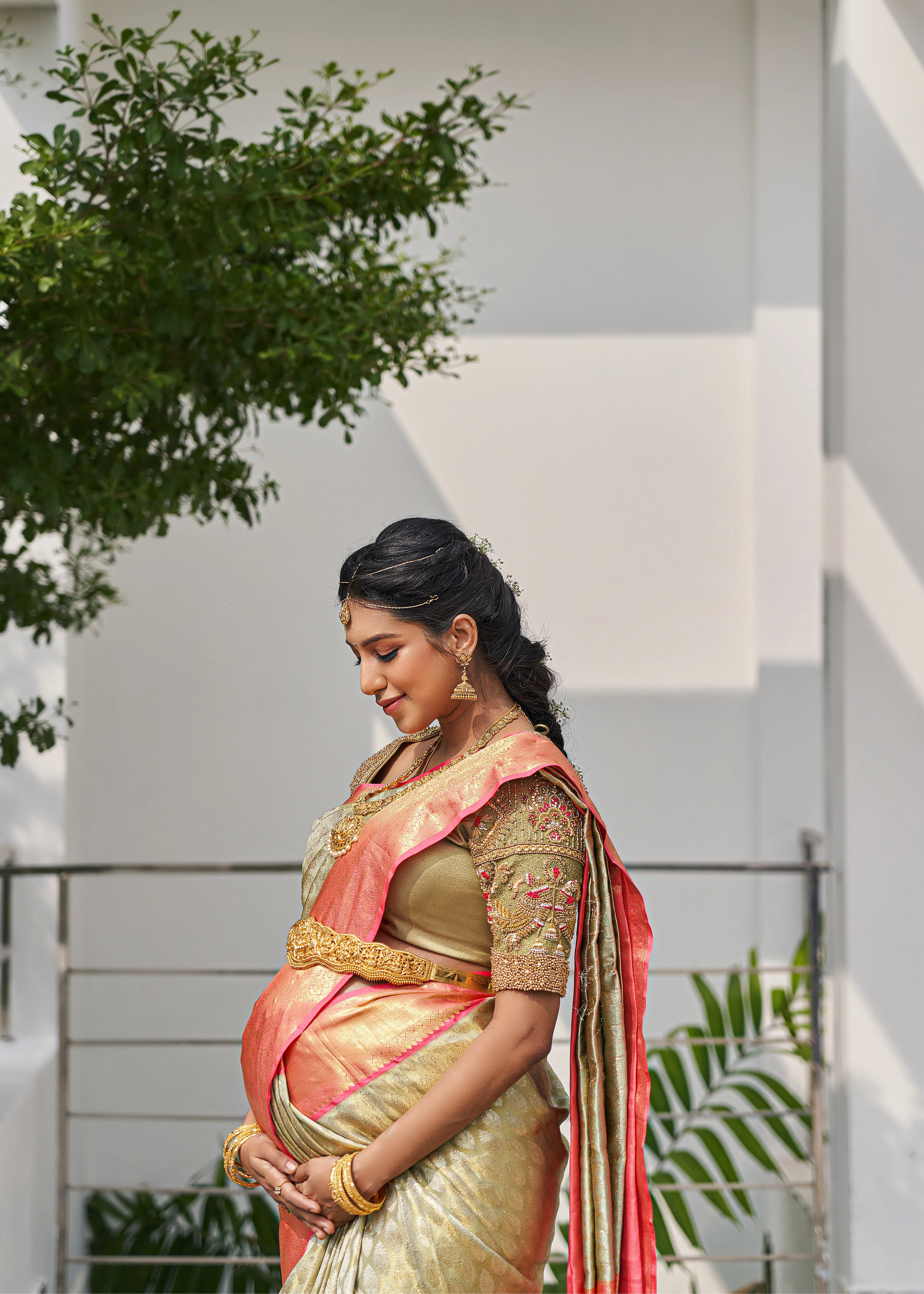 Model Ashwini Kumar, one of the mommies to be for whom Archana Karthick designed the blouse for her baby shower is posing for a side profile.