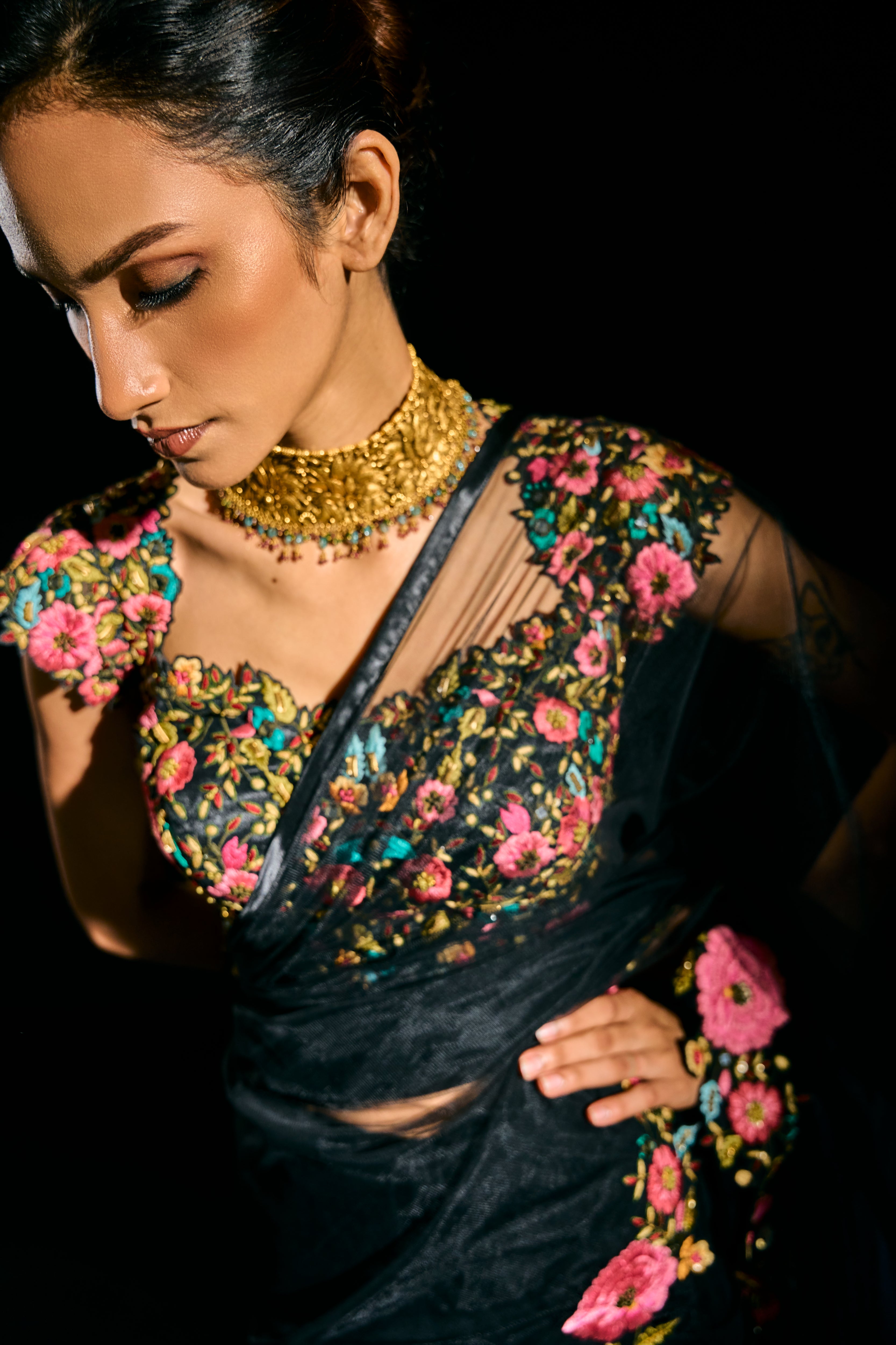 Model Esha Gohil in a closeup pic in black tulle drape and embroidered with floral resham that gleam like whispers in the dark. Handcrafted for "HAZE" - A/W'25 capsule collection by Archana Karthick.