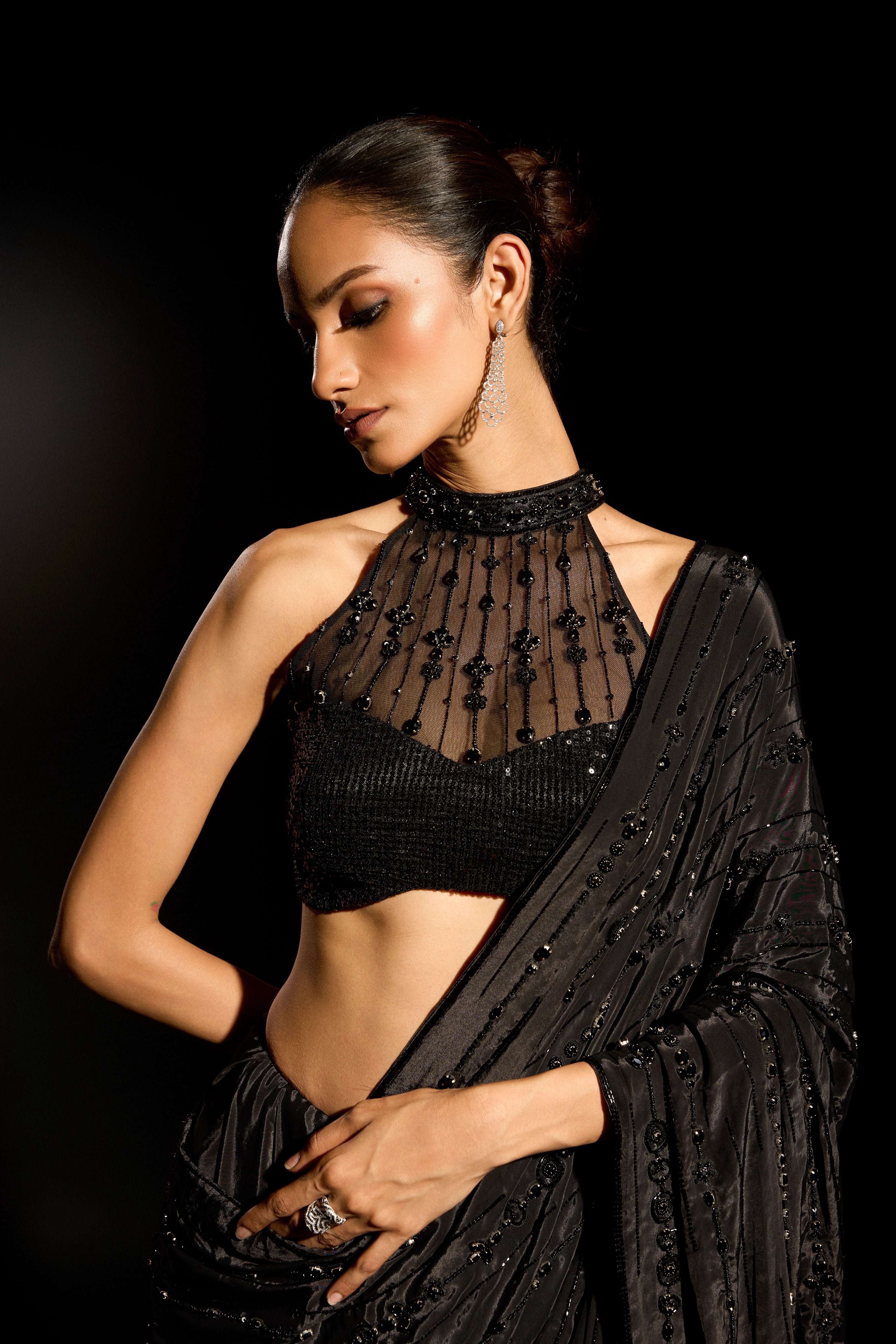 Model Esha Gohil posing for a closeup during photoshoot in a black saree set is intricately adorned with sequins, rhinestones and cutdana for "STARDUST" - A/W'25 saree collection by team Archana Karthick.