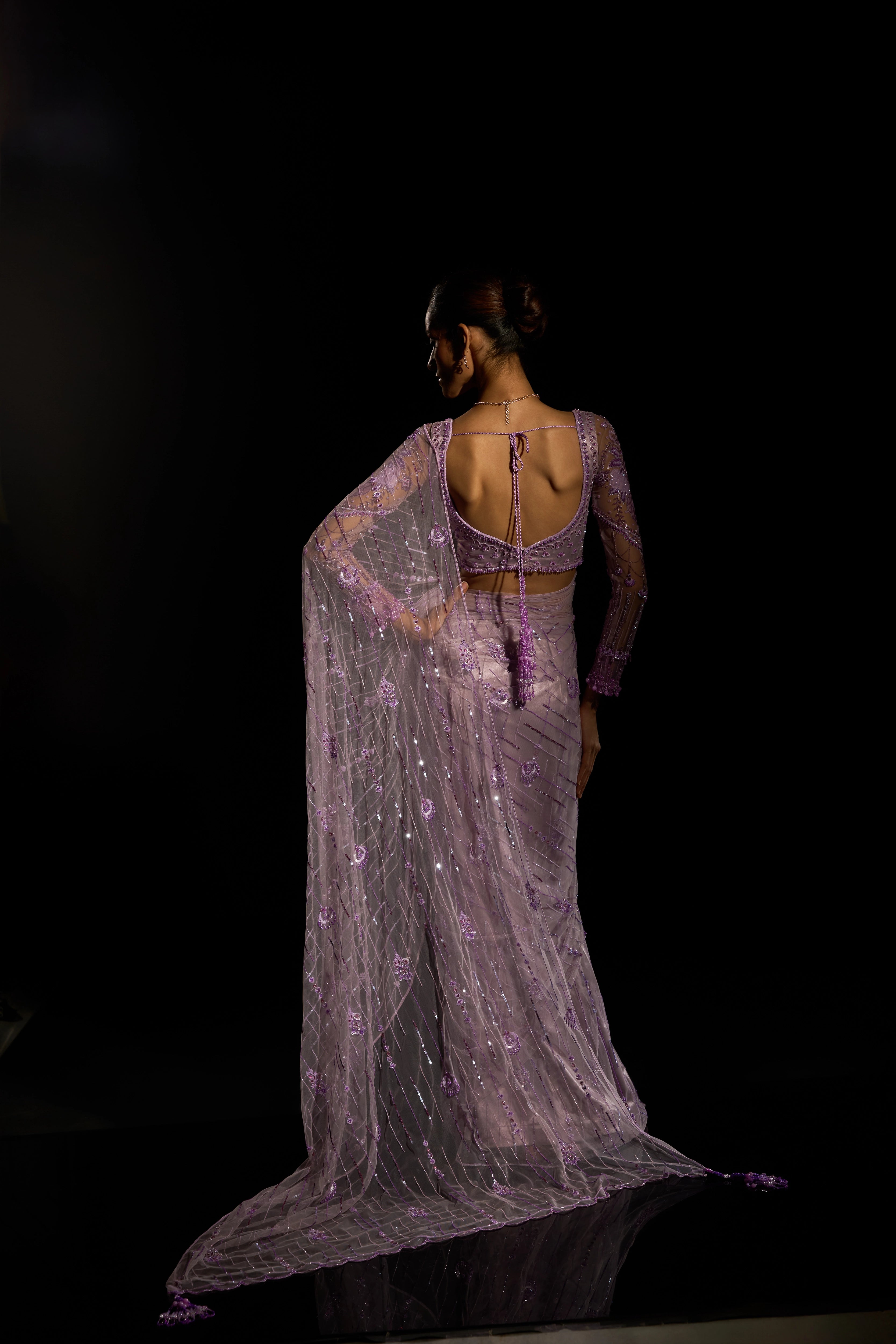 Model Esha Gohil posing for back design in a lavender saree set intricately adorned with sequins, rhinestones, crystals and cutdana for "STARDUST" - A/W'25 saree collection by team Archana Karthick.