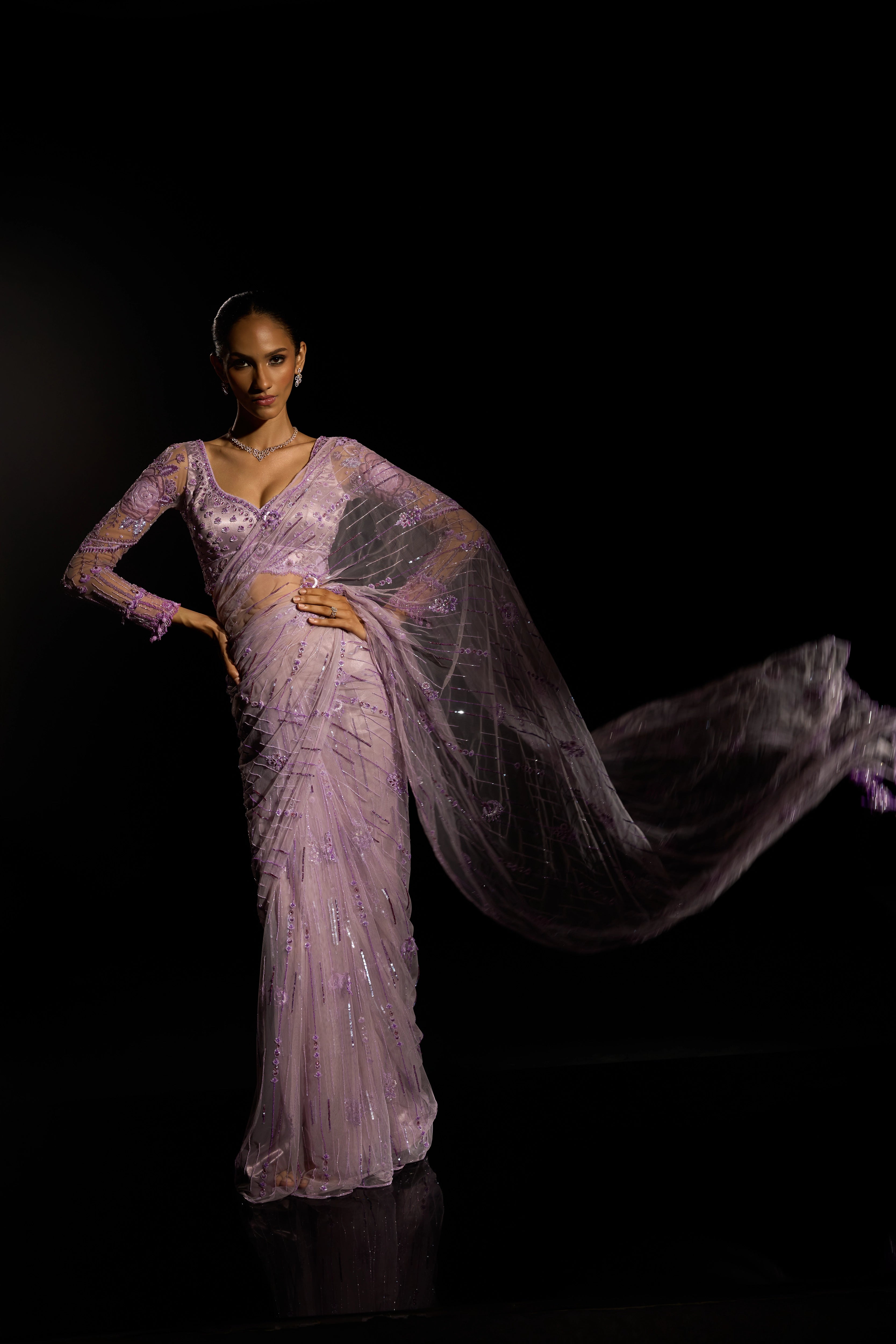 Model Esha Gohil posing for photoshoot in a lavender saree set intricately adorned with sequins, rhinestones, crystals and cutdana for "STARDUST" - A/W'25 saree collection by team Archana Karthick.