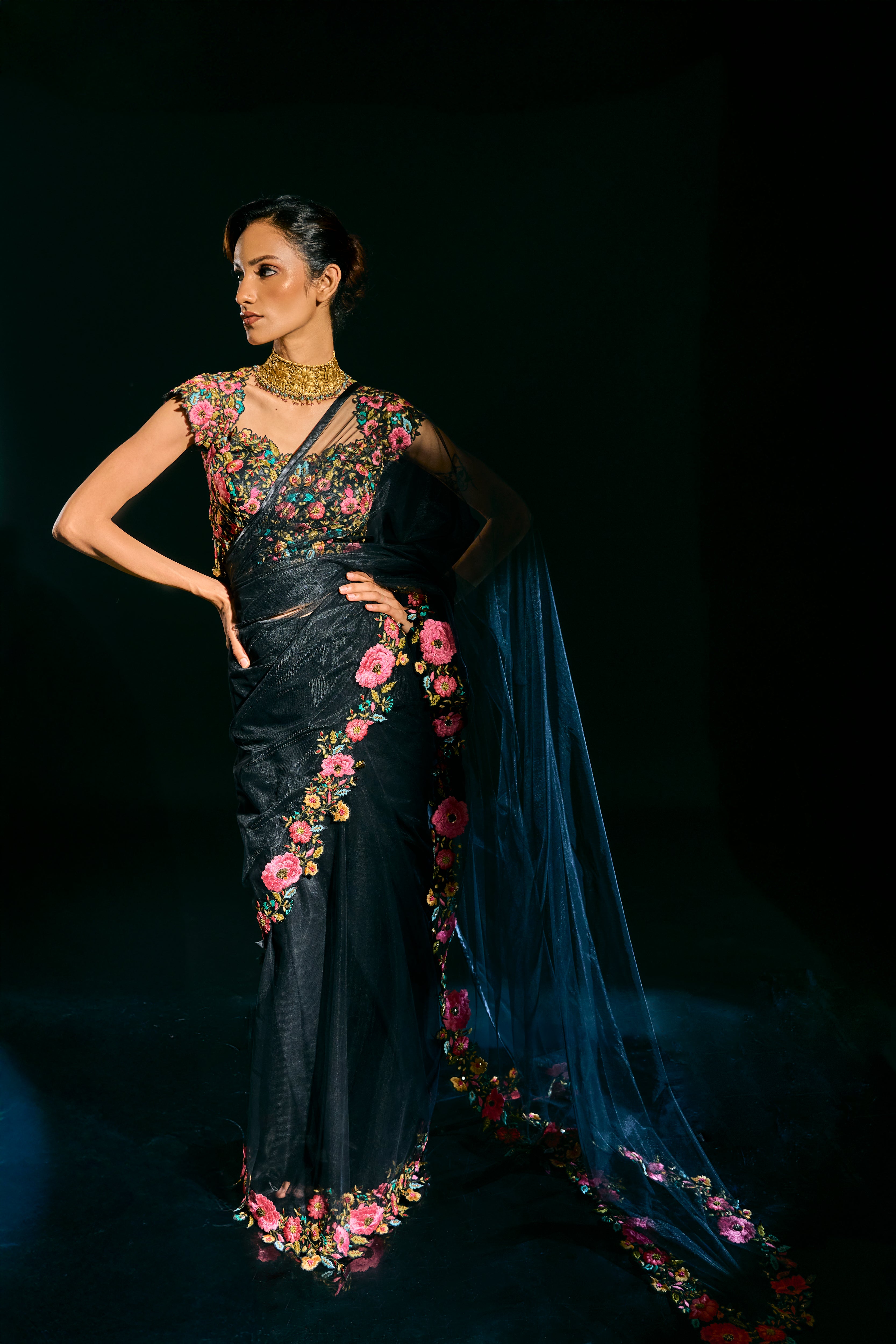 Model Esha Gohil showcasing entire design in black tulle drape and embroidered with floral resham that gleam like whispers in the dark. Handcrafted for "HAZE" - A/W'25 capsule collection by Archana Karthick.