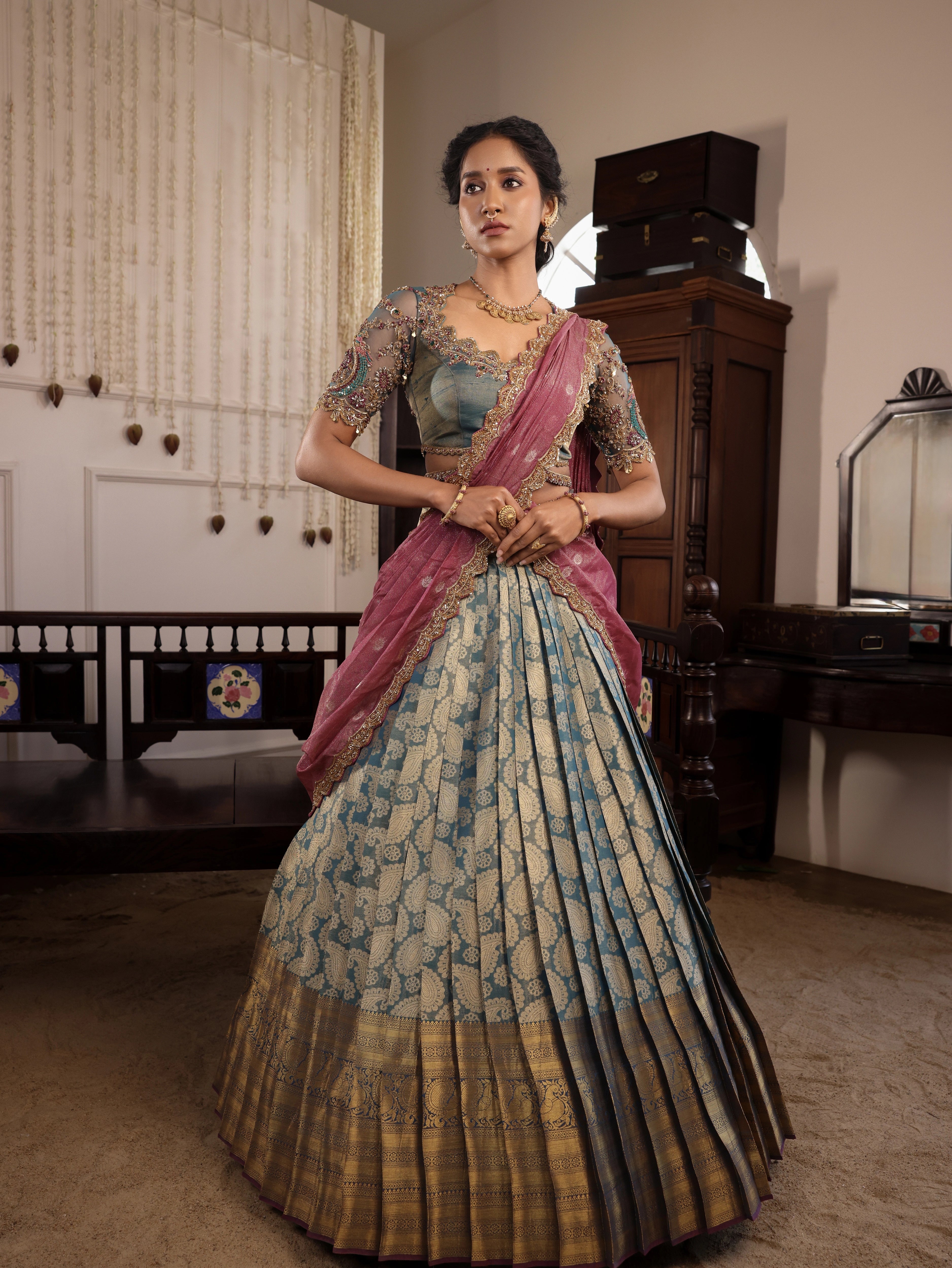 Model Gayathri Dhanasekar in a green silk half saree handcrafted by team Archana Karthick. Styled with jewelry sets from vummidi bangaru jewellers.