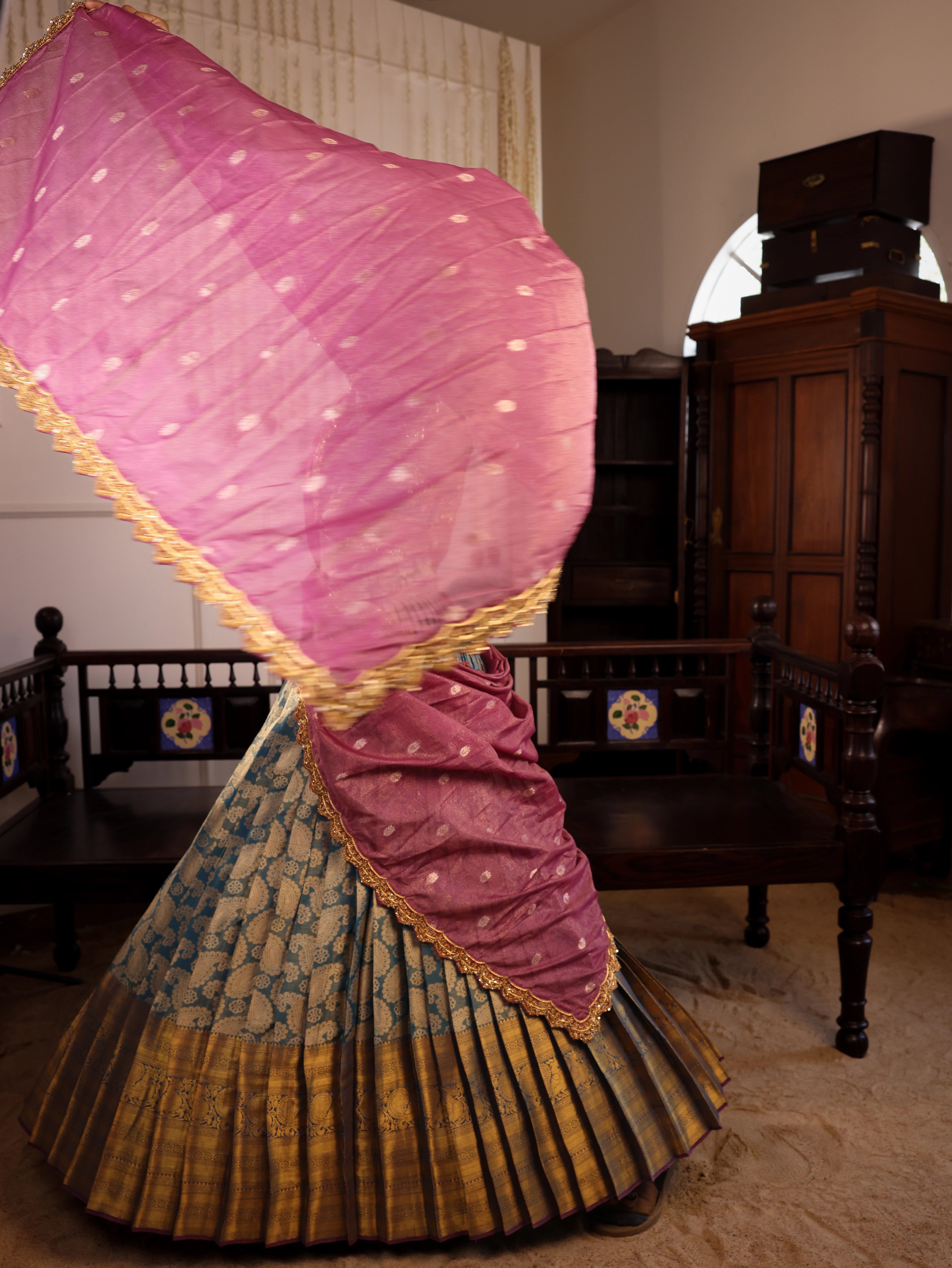 Model Gayathri Dhanasekar showcasing dupatta in a green silk half saree handcrafted by team Archana Karthick. Styled with jewelry sets from vummidi bangaru jewellers.