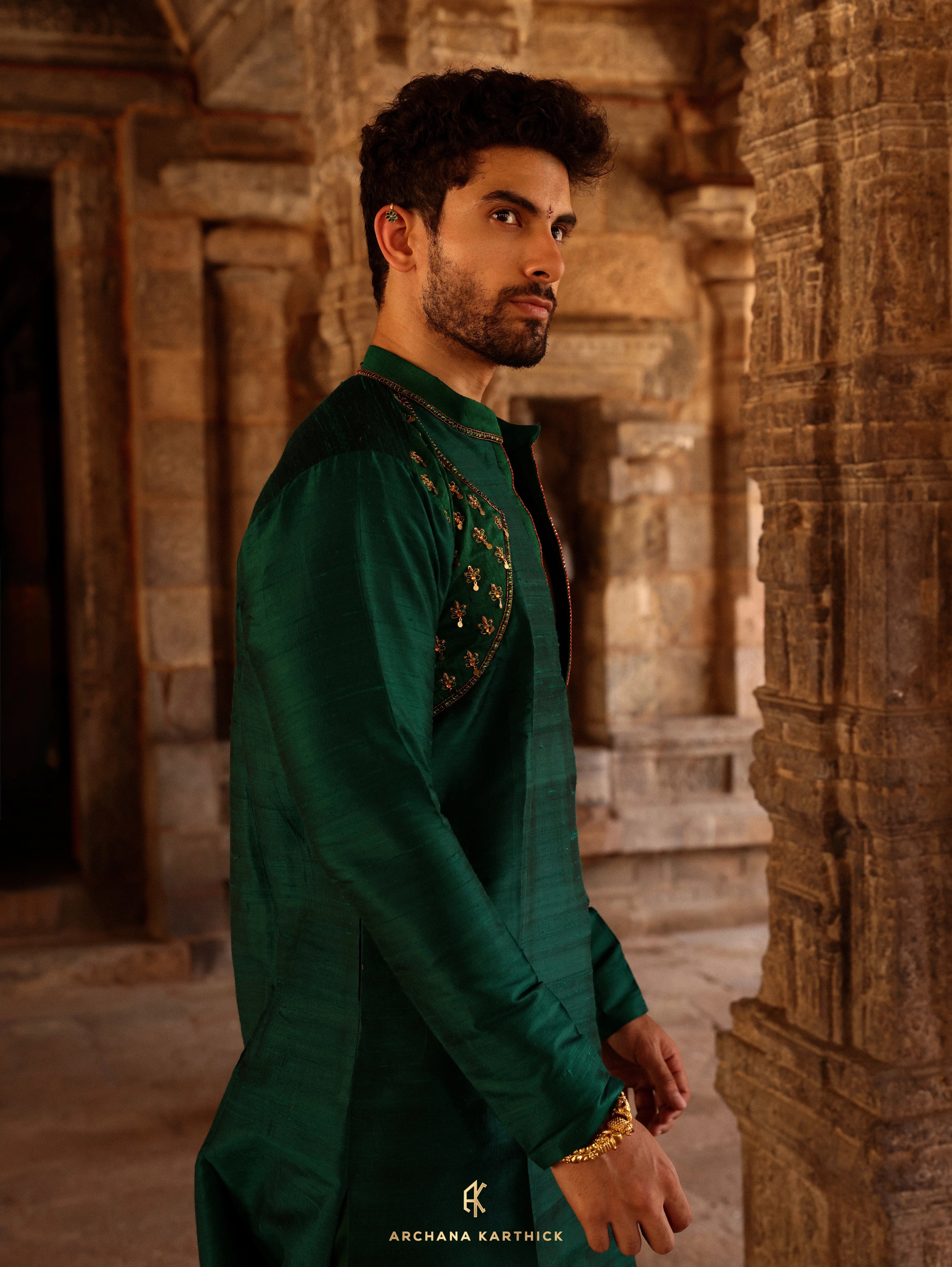 Model Harsh Kapoor posing in green raw silk mens kurta set by chennai-based luxury couture label Archana Karthick