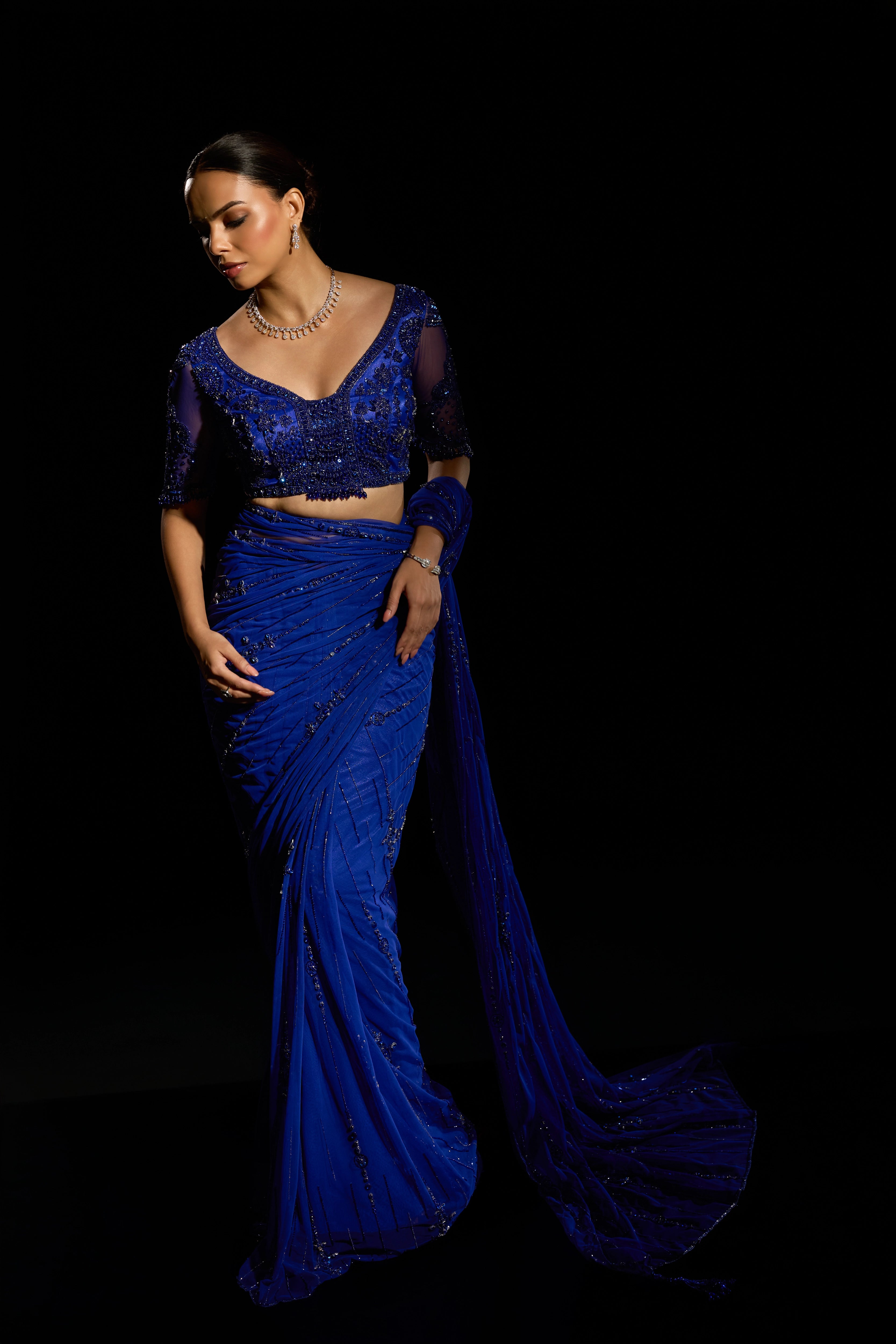 Model Jane C Thompson in a sapphire blue saree set intricately adorned with sequins, rhinestones, crystals and cutdana for "STARDUST" - A/W'25 saree collection by team Archana Karthick.