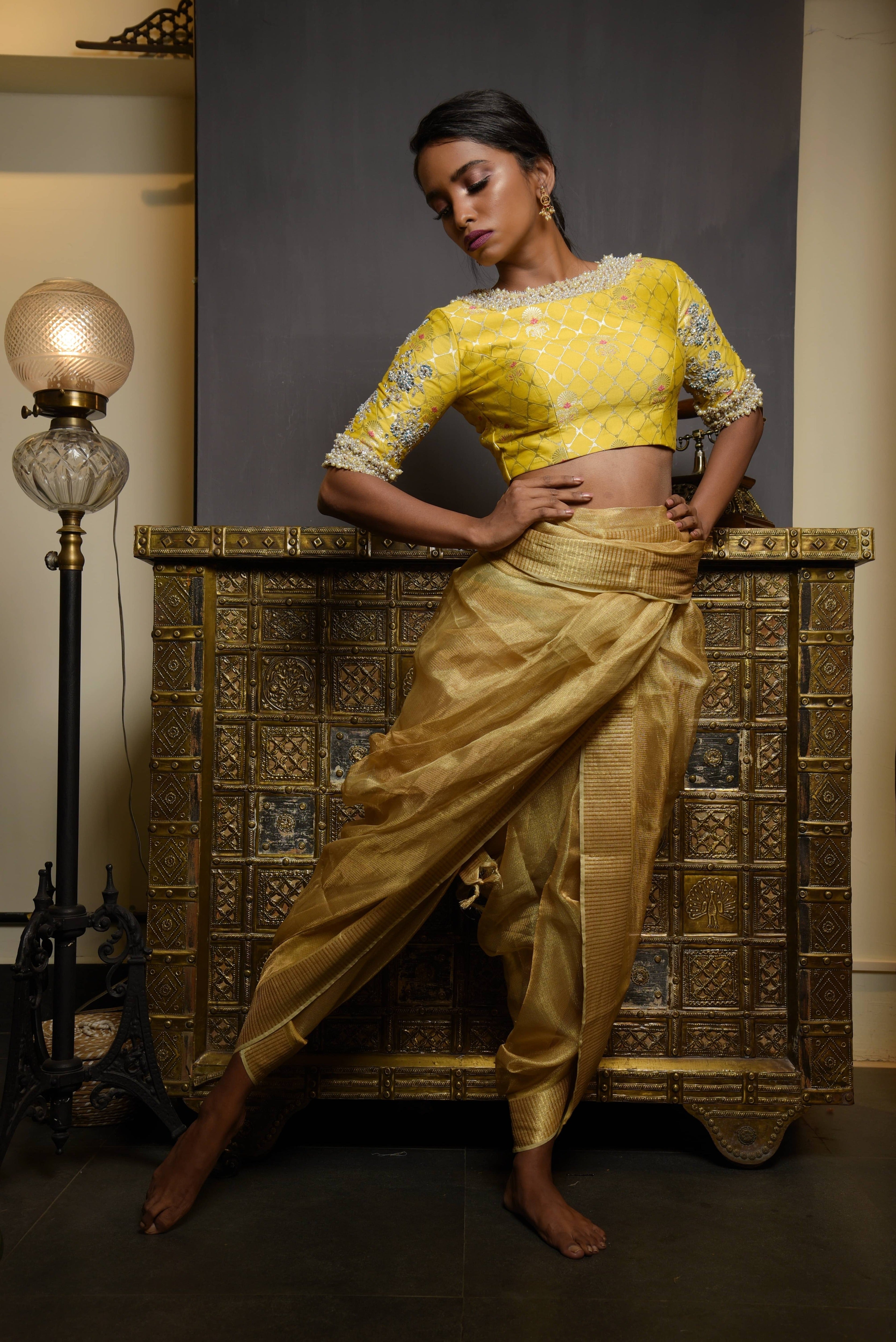 Model Pravallika Prasanna Raju posing for full front profile in a yellow banarasi silk blouse with pearl embellishments on sleeves.