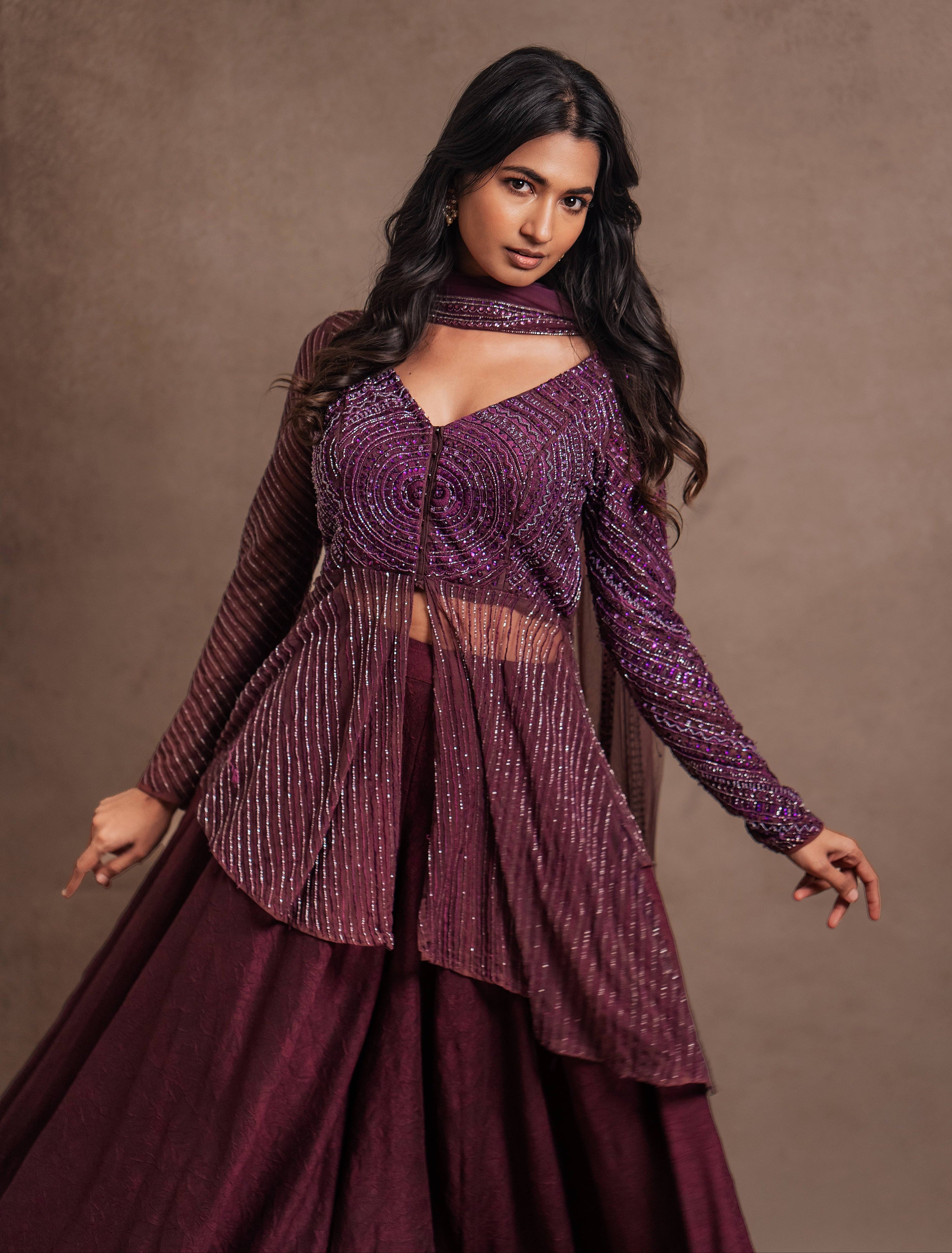 Model Premika Sekar in aubergine peplum sharara posing for a twirl