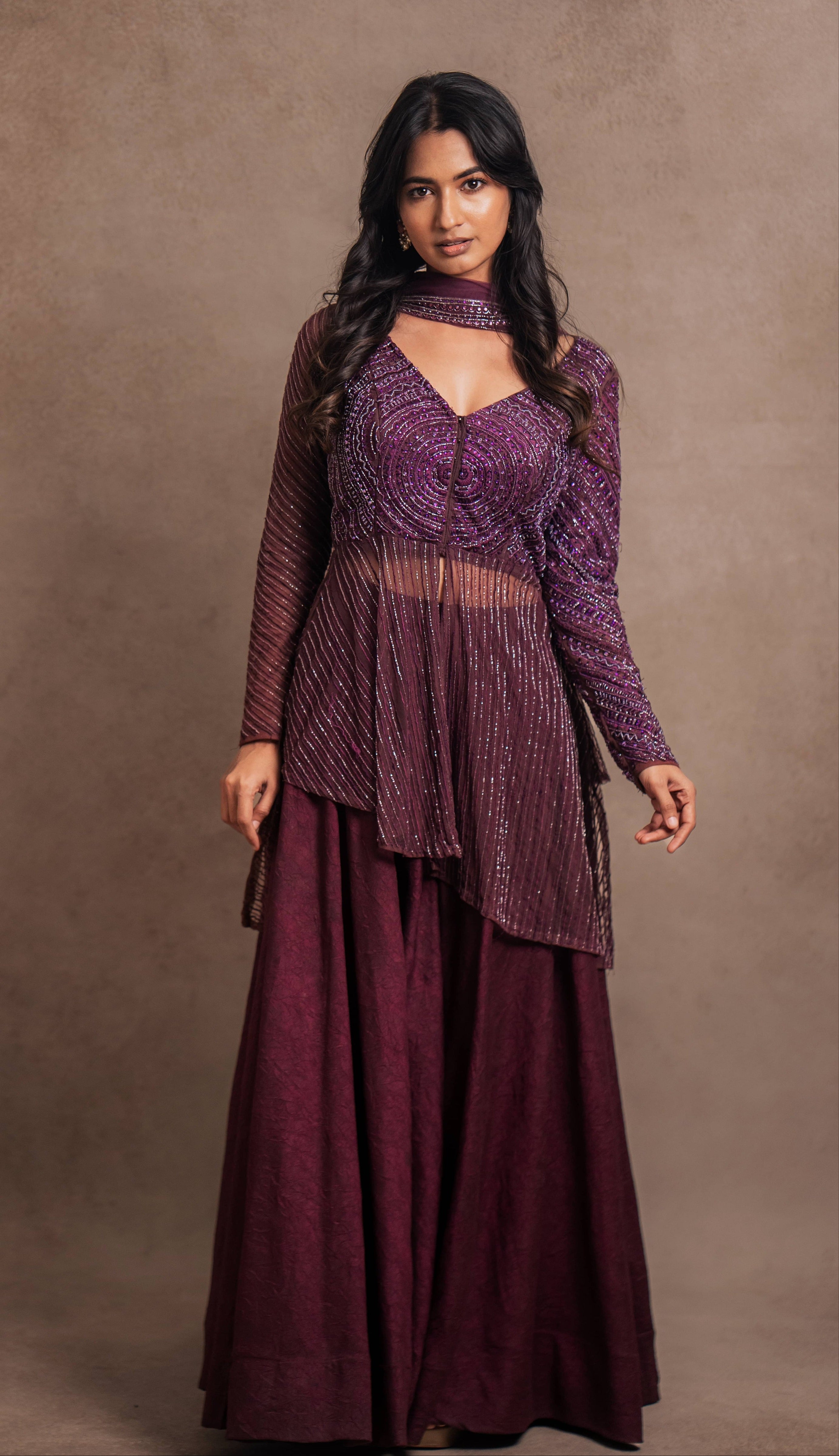 Model Premika Sekar in aubergine peplum sharara posing for camera