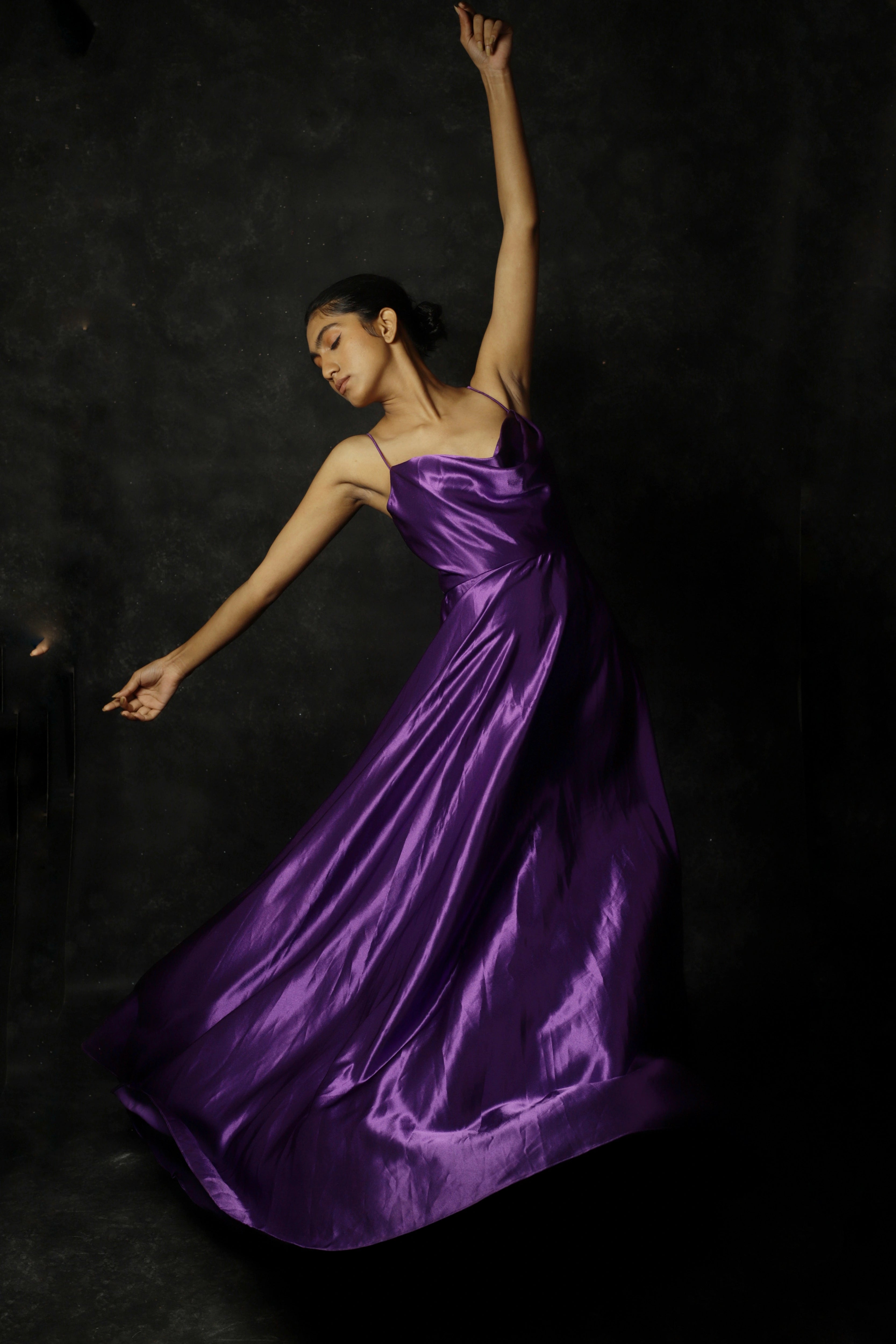 Model Rali Alph posing for photoshoot in a sleeveless violet satin slip dress by team Archana Karthick.