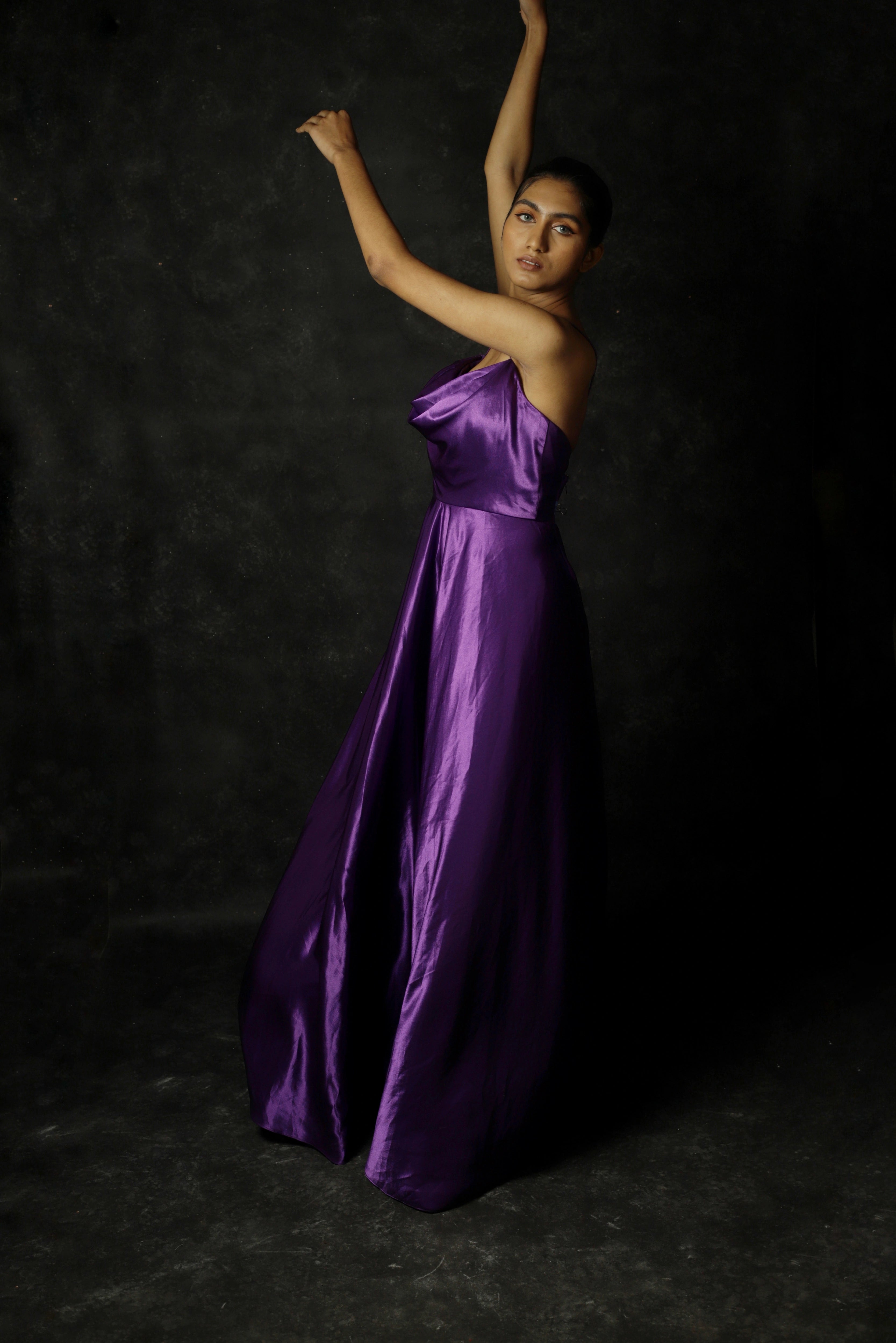 Model Rali Alph posing in a sleeveless violet satin slip dress by team Archana Karthick.
