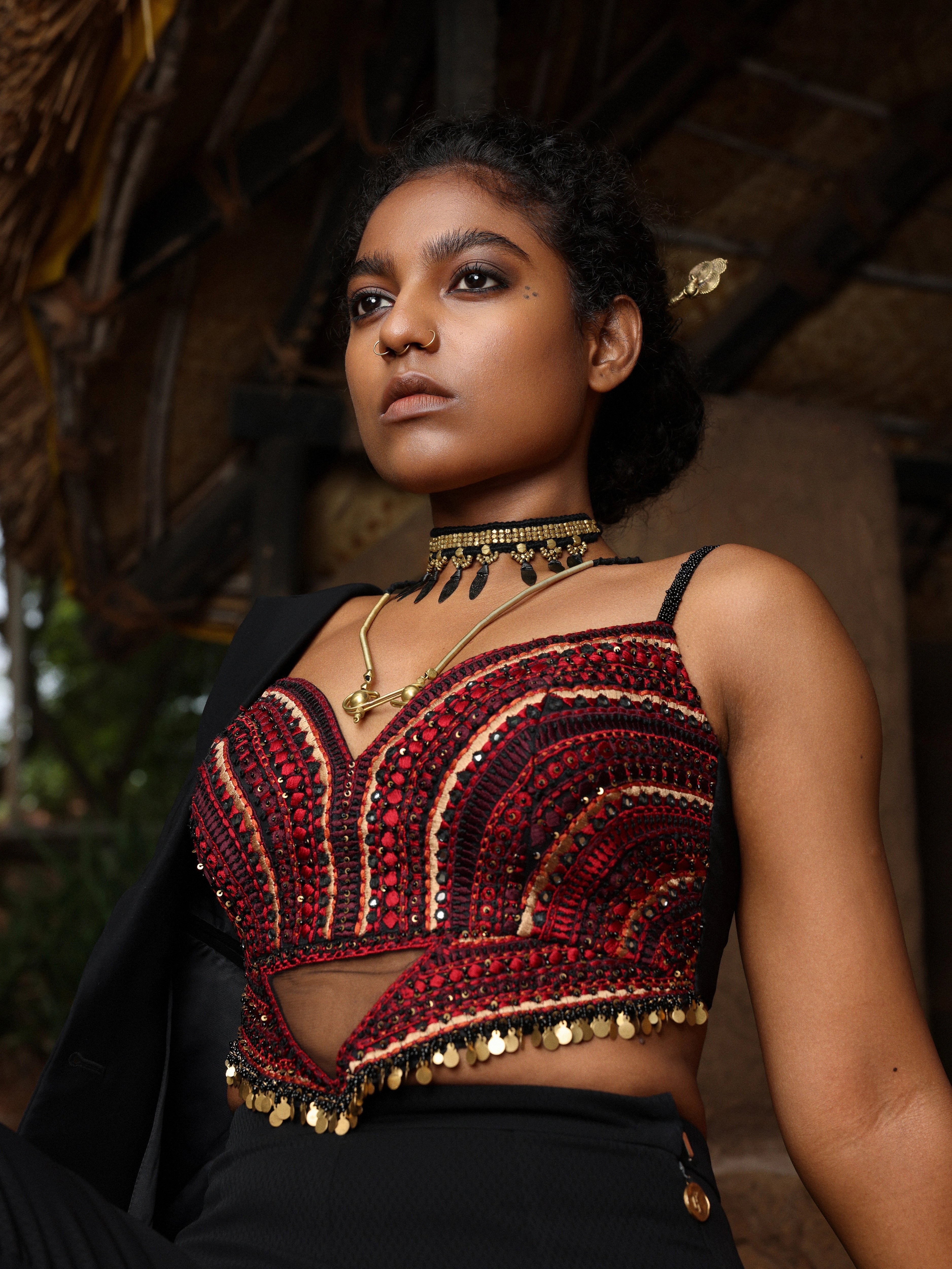 Model in black pantsuit showcasing handcrafted corset detailings.