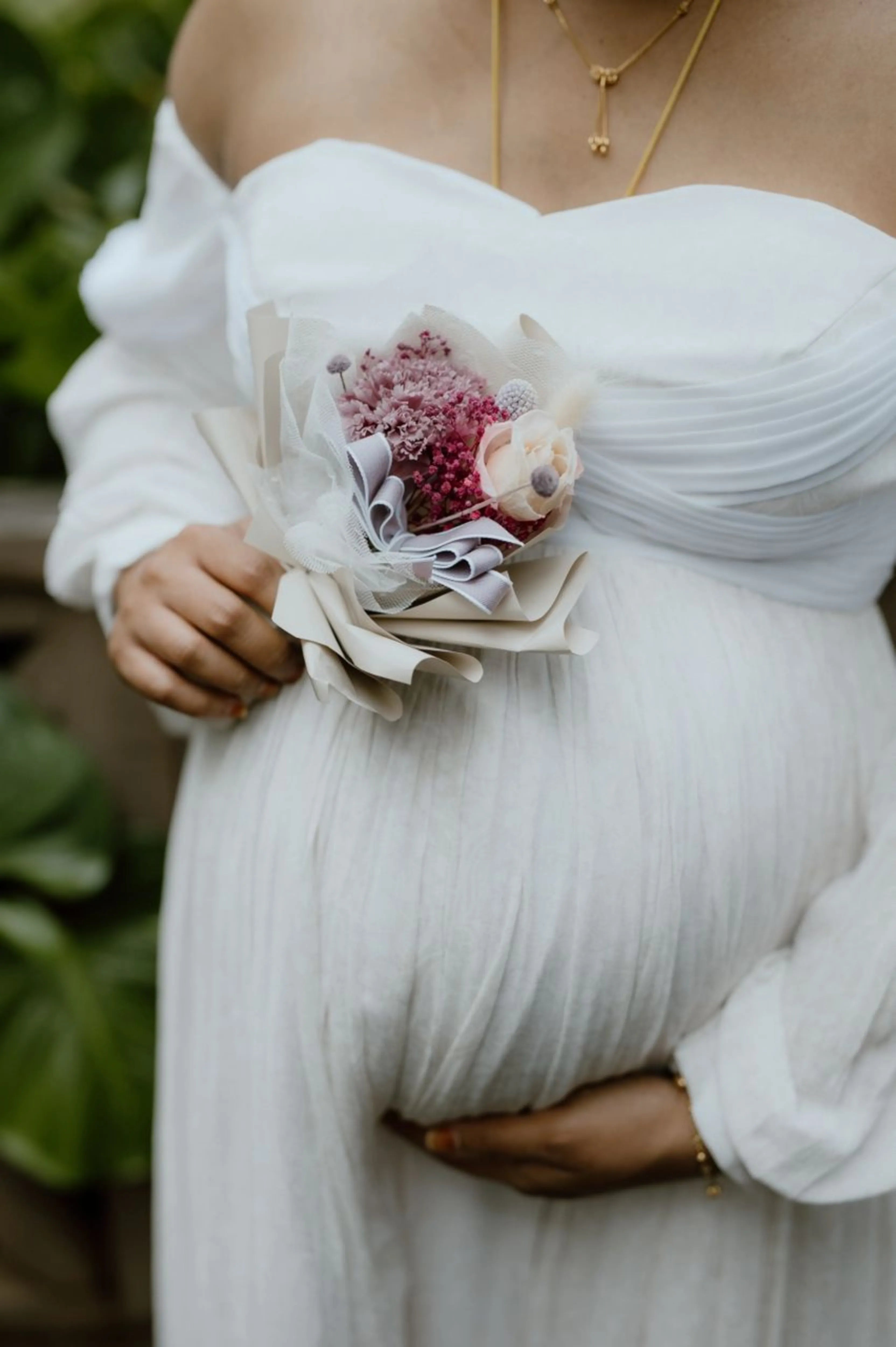 Mom to be Anusha Rajendran from Singapore posing in a white georgette corset maternity gown by Archana Karthick.