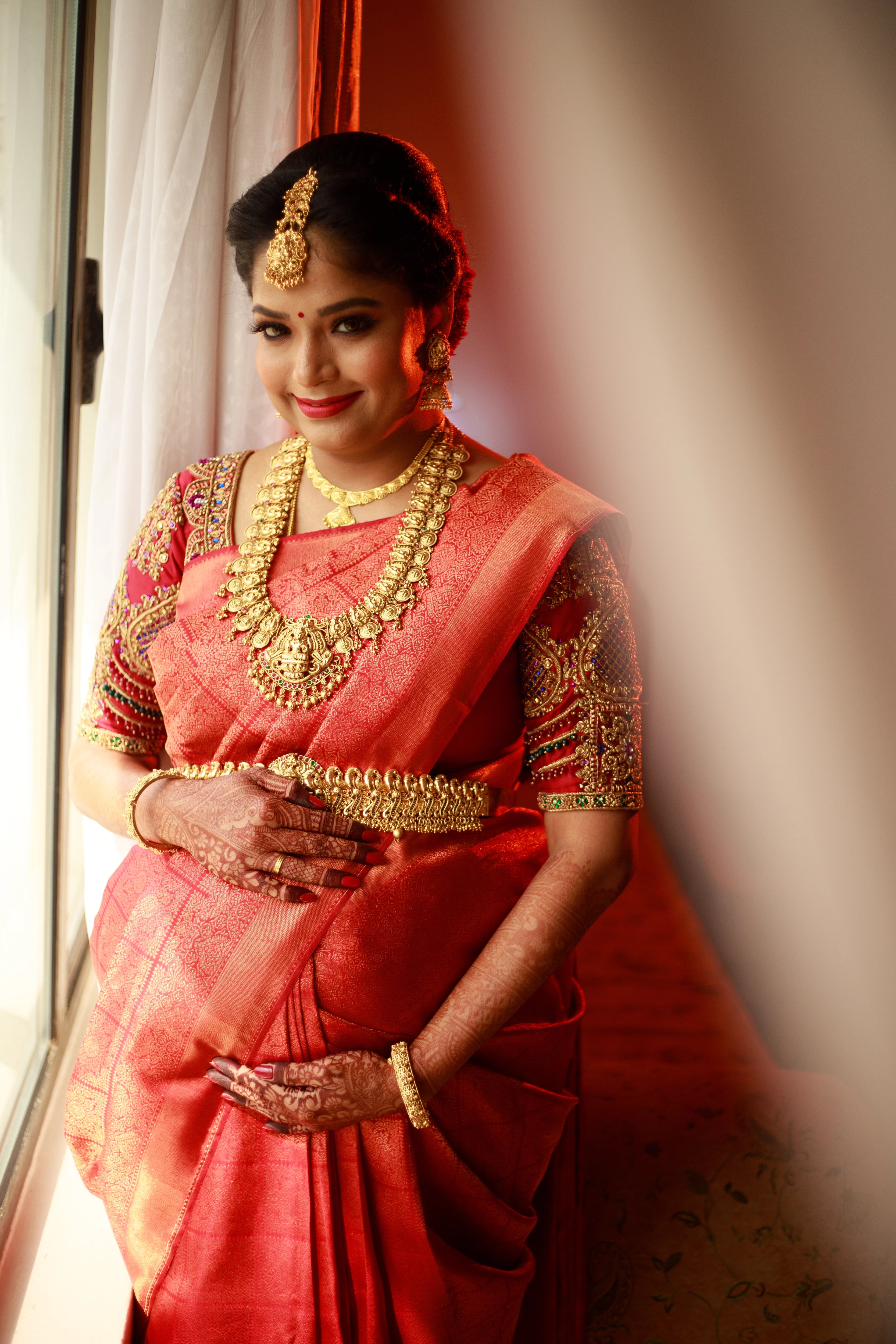 Mom to be Gayathri Kiran Kumar in a red silk blouse for her baby shower / seemantham, intricately handcrafted with kemp stones, zardozi and beads by team Archana Karthick.