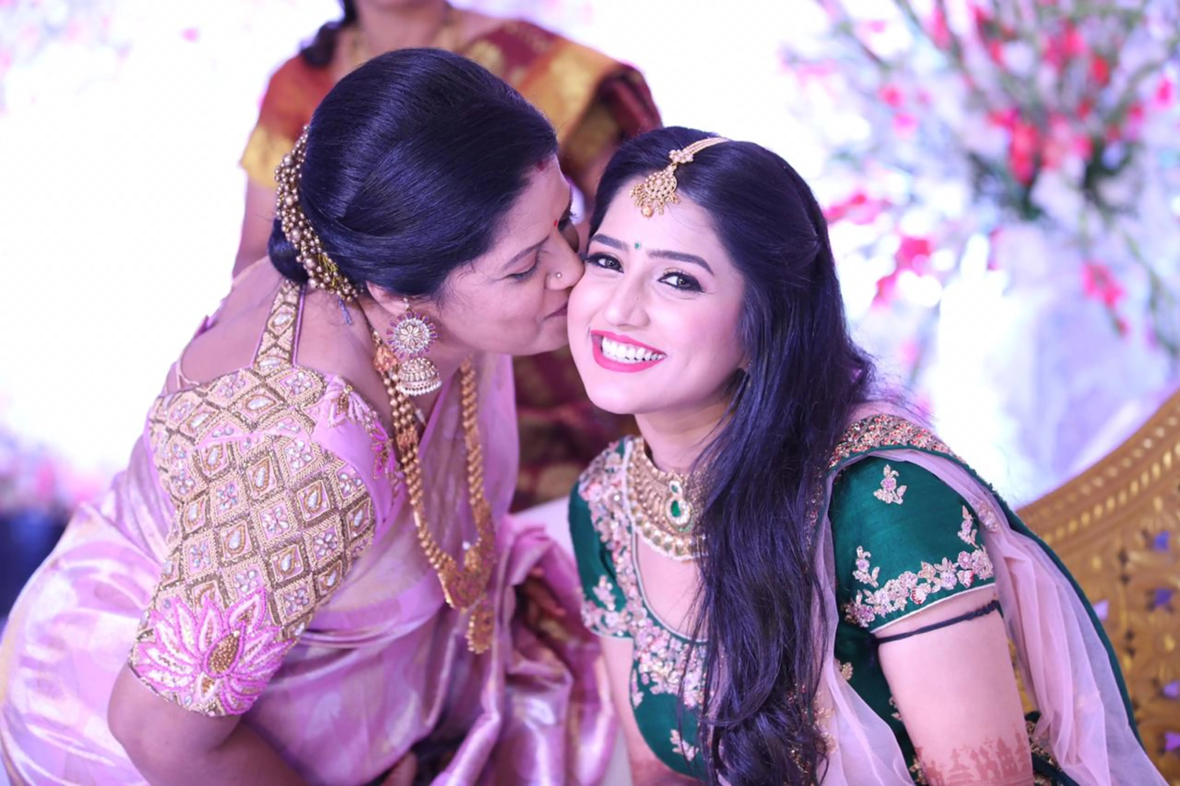 Mother of the bride in a pink silk blouse, handcrafted by team Archana Karthick.