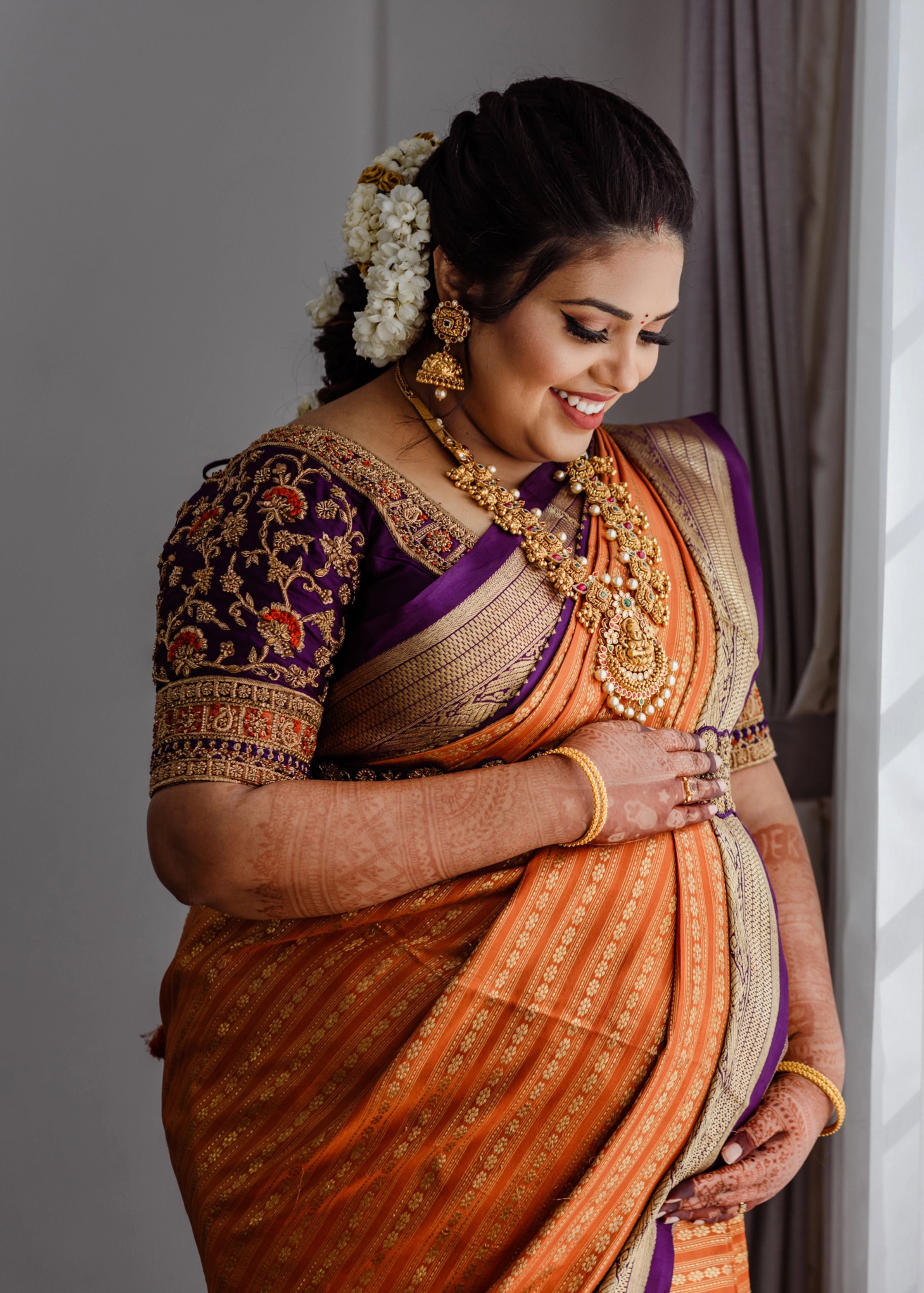 Mother to be, Dr Nishitha in a purple silk blouse handcrafted by team Archana Karthick.