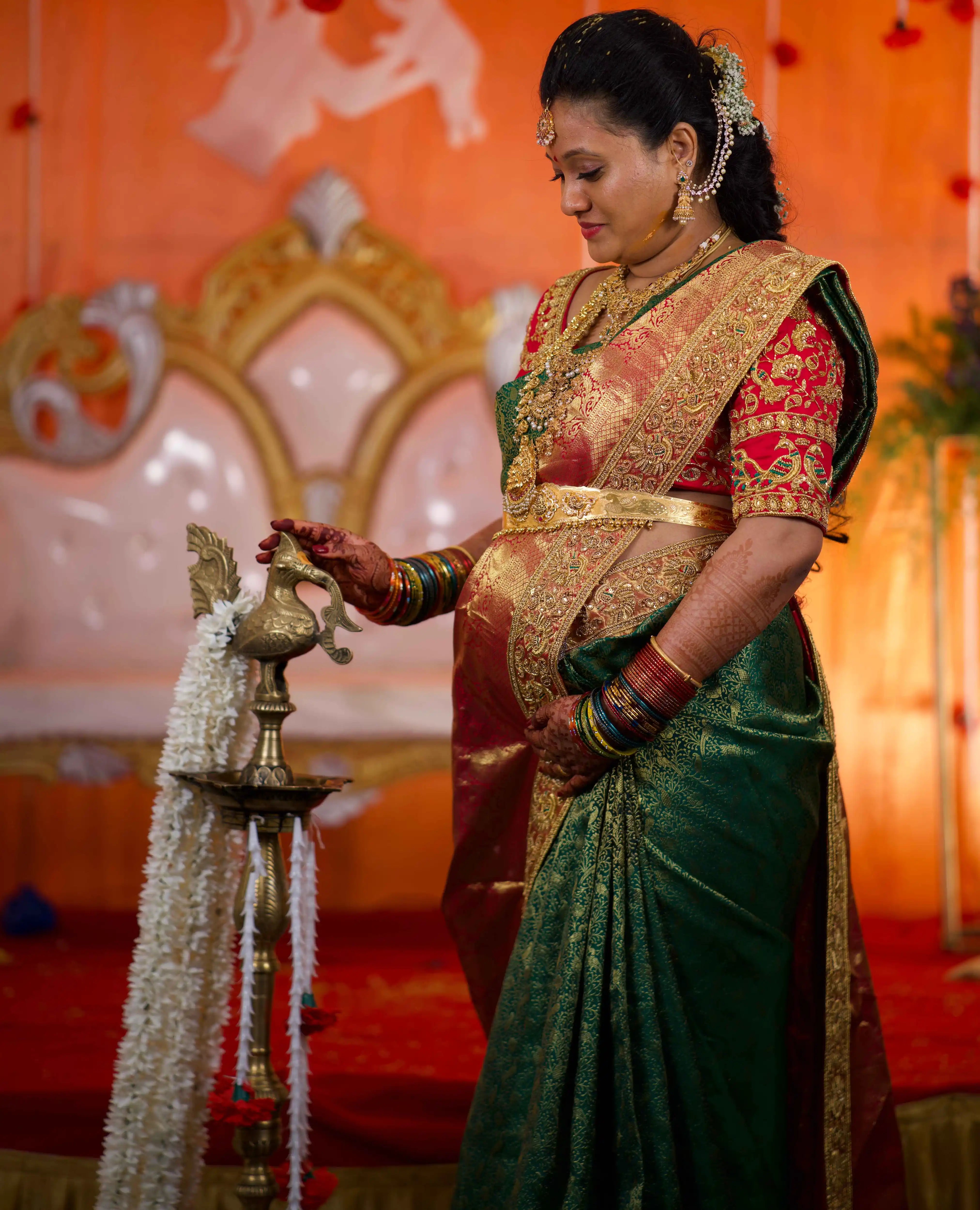 Mother to be, Swathi Pillai from Seattle, USA in a pink raw silk blouse and saree border handcrafted by team Archana Karthick.