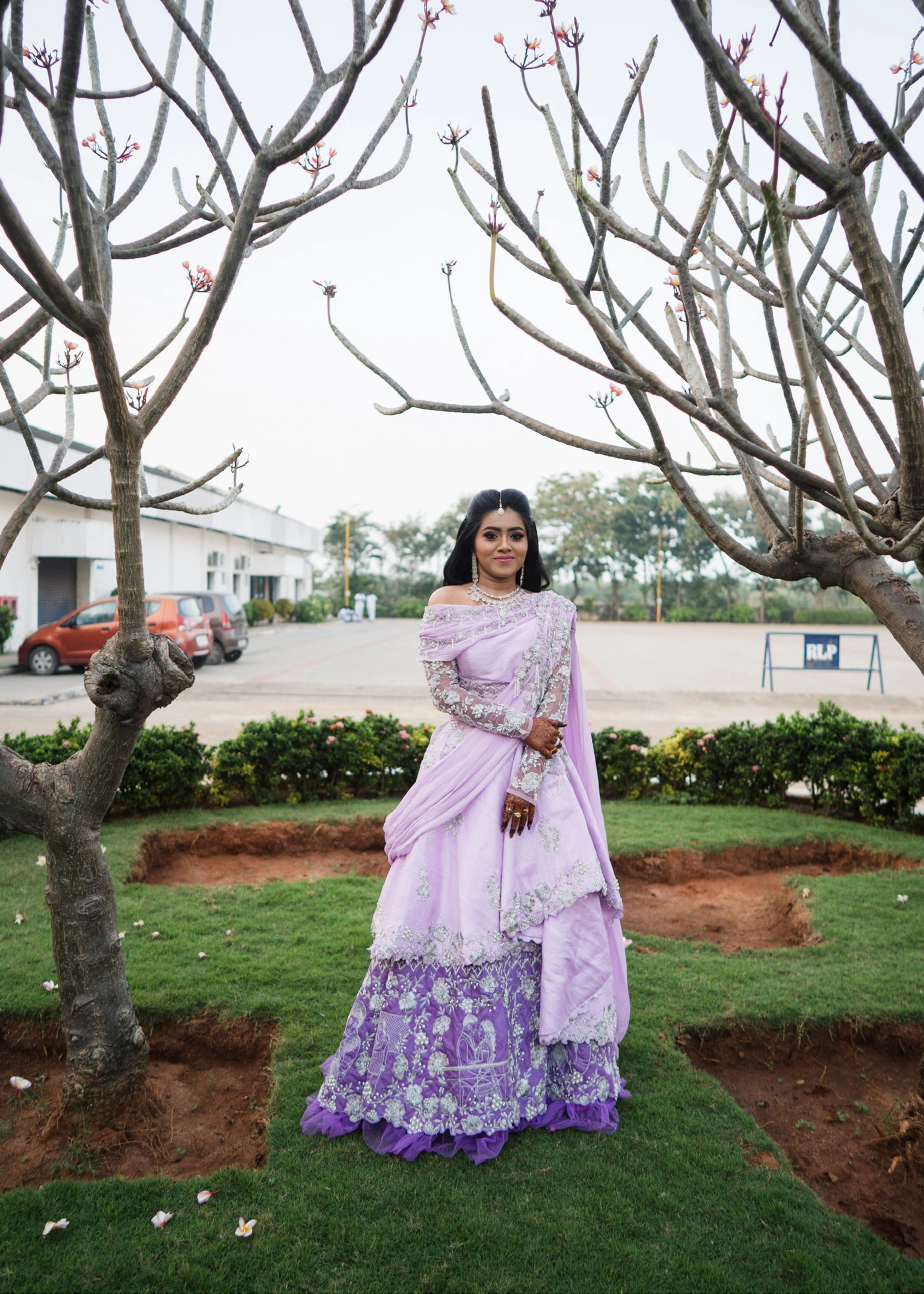 Nisha in a lilac raw silk one-shoulder lehenga handcrafted by team Archana Karthick.