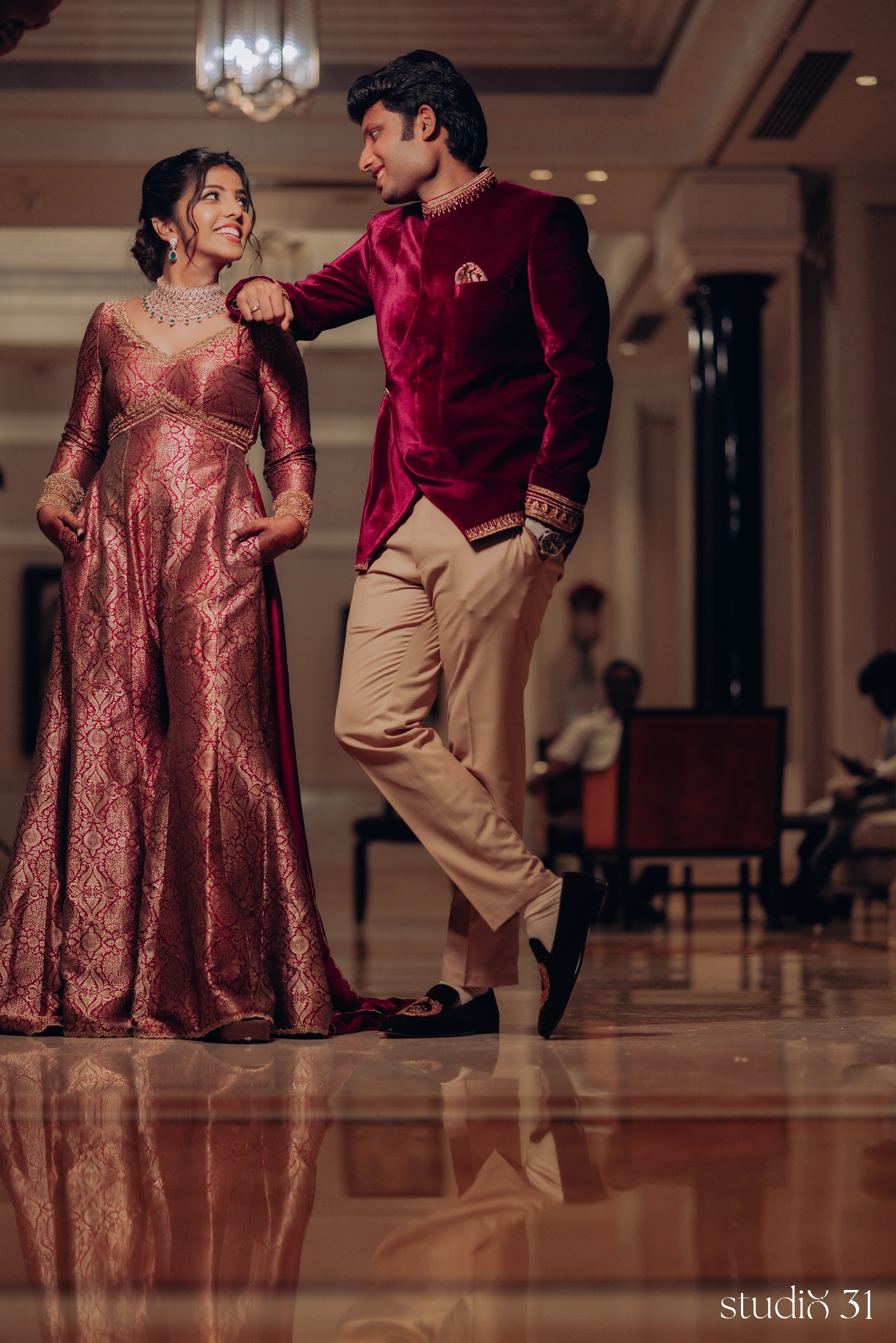 Pooja & Rhevanth for their engagement in a maroon ensemble by Archana Karthick