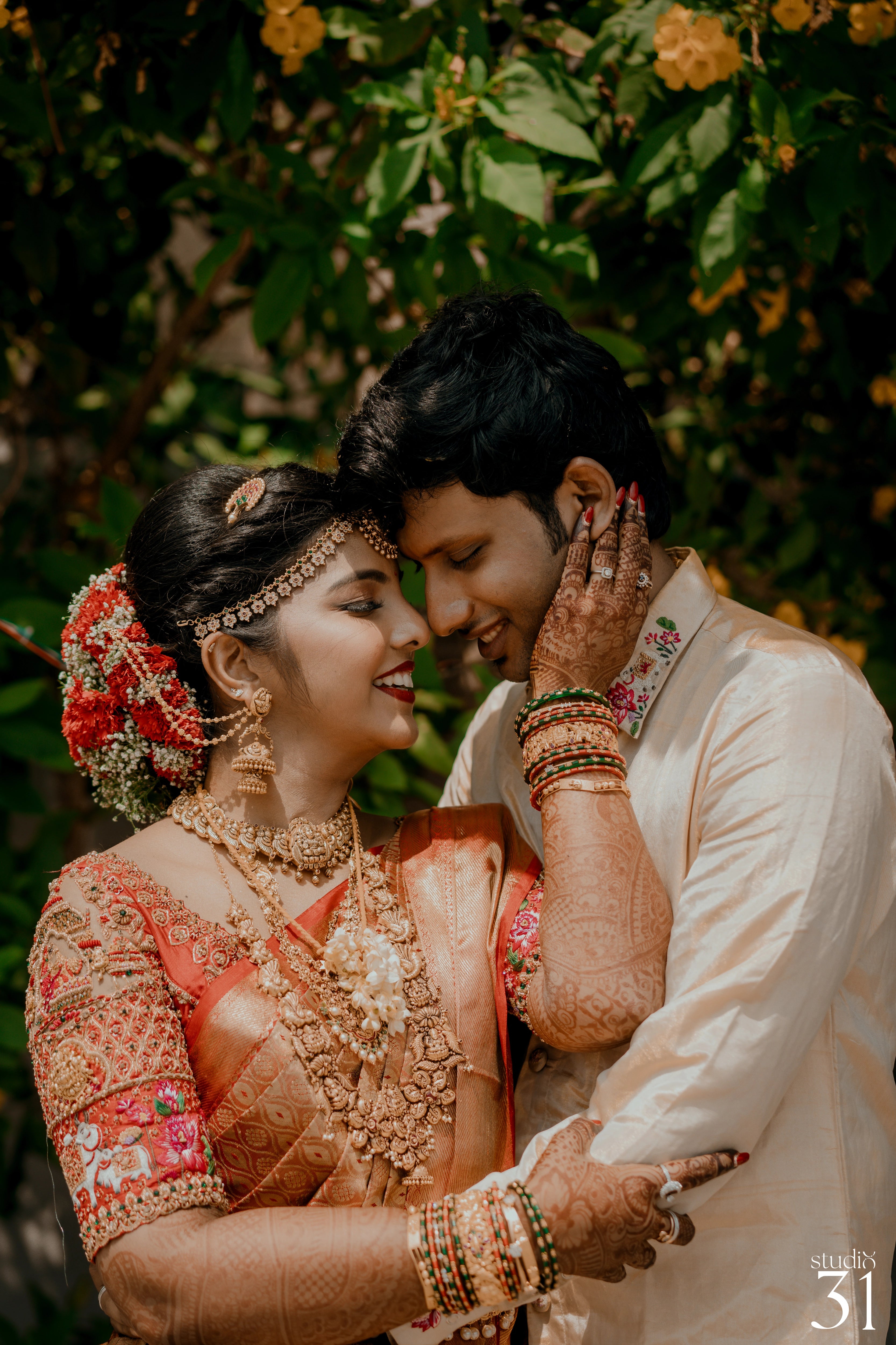 Pooja & Rhevanth for their wedding in red silk blouse and white silk veshti and shirt - intricately handcrafted by team Archana Karthick.