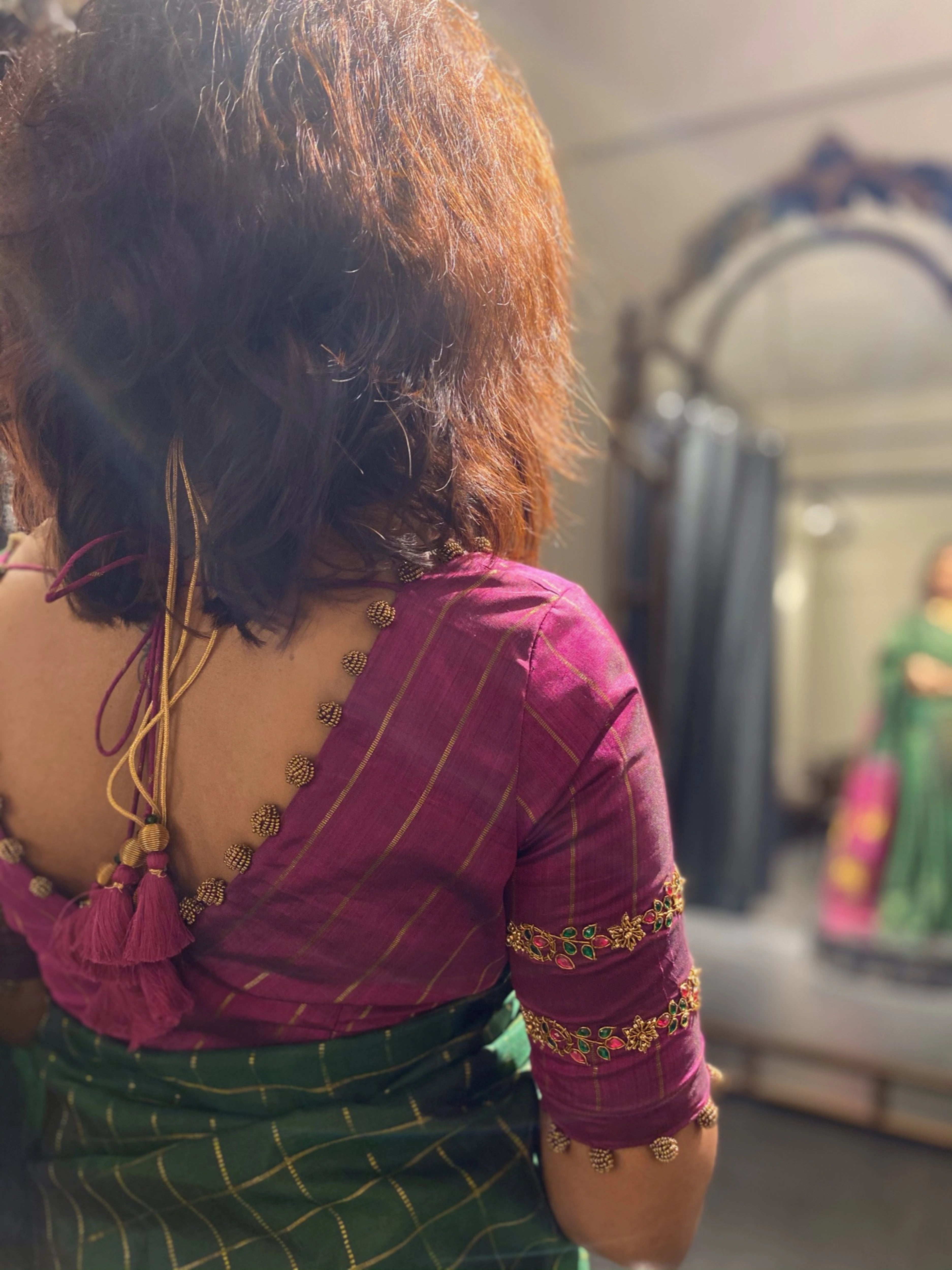 Sasi during fittings in a dark magenta silk blouse, handcrafted by team Archana Karthick.